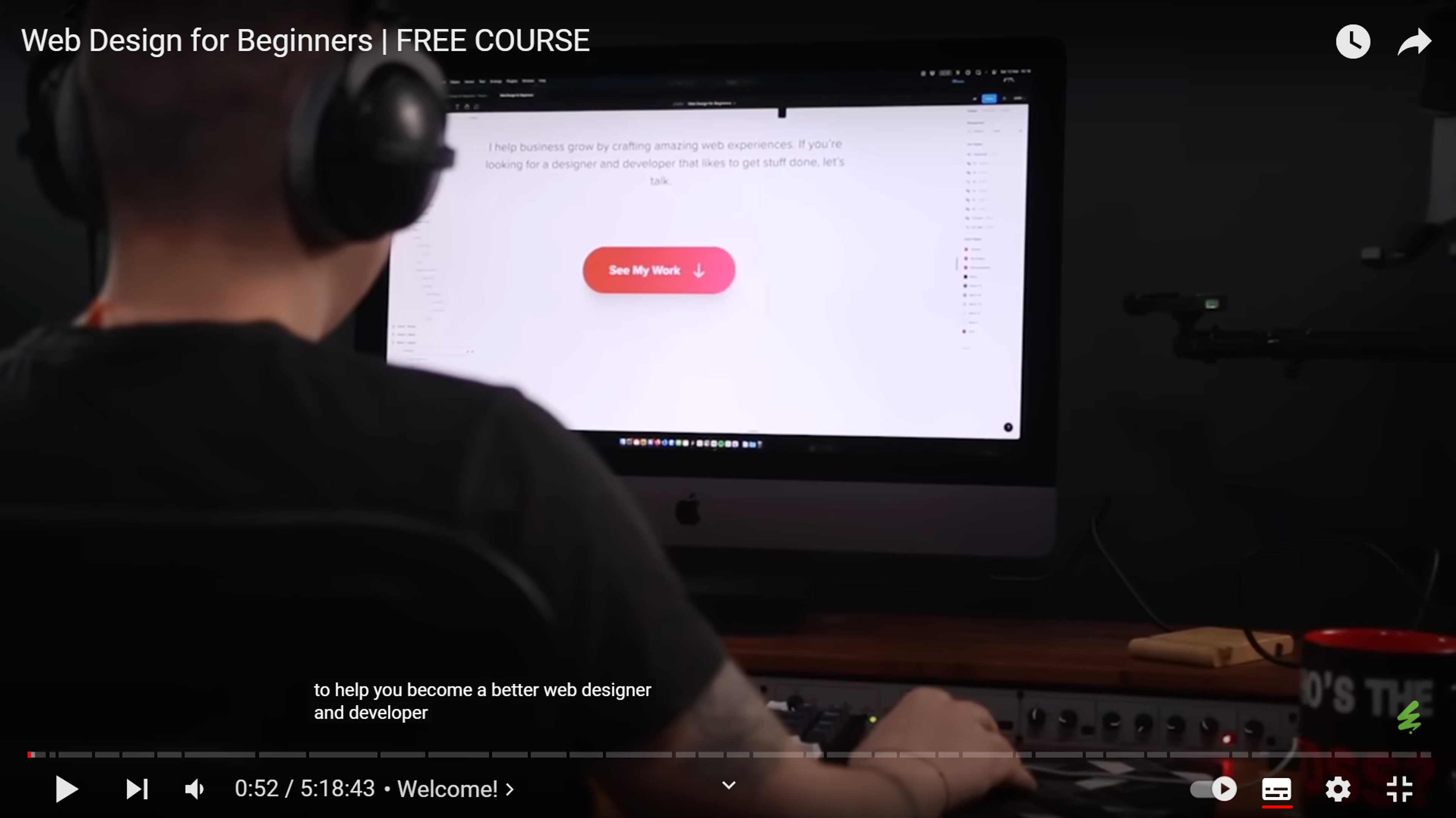 A person learning web design at their desk while watching a free web design course