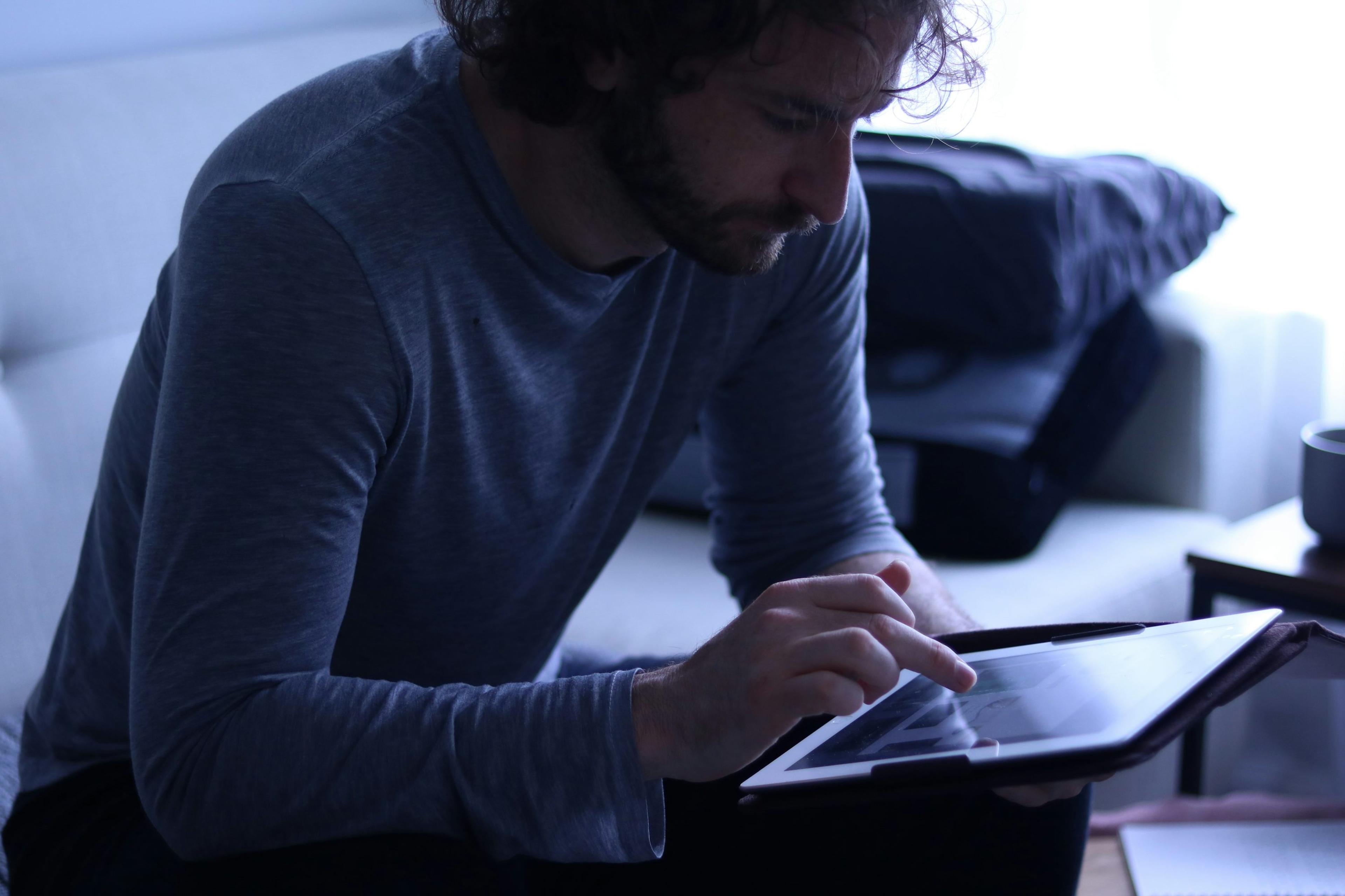 Person using a tablet in a dimly lit room