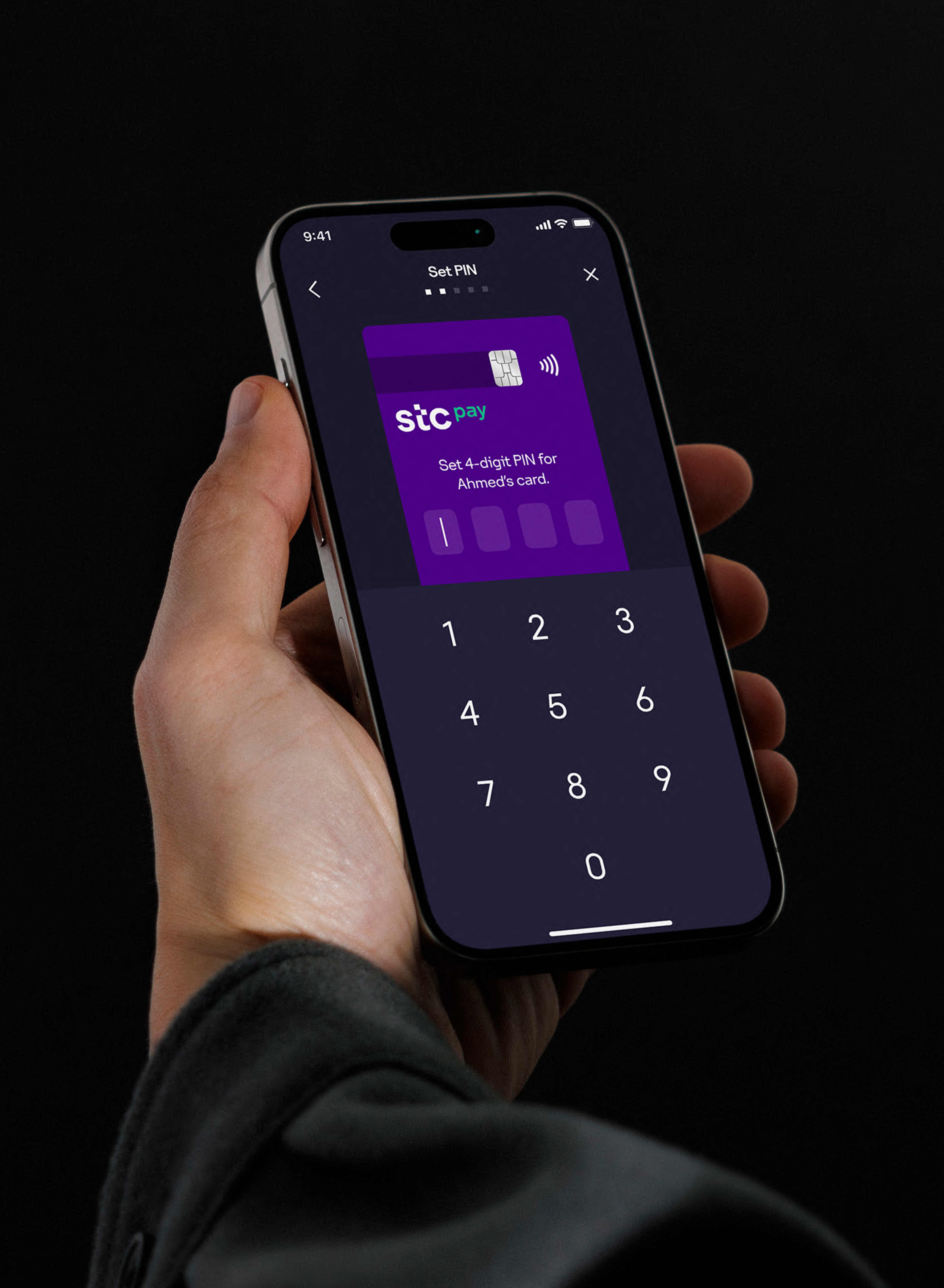 A person holding a phone with the STC Bank app opened