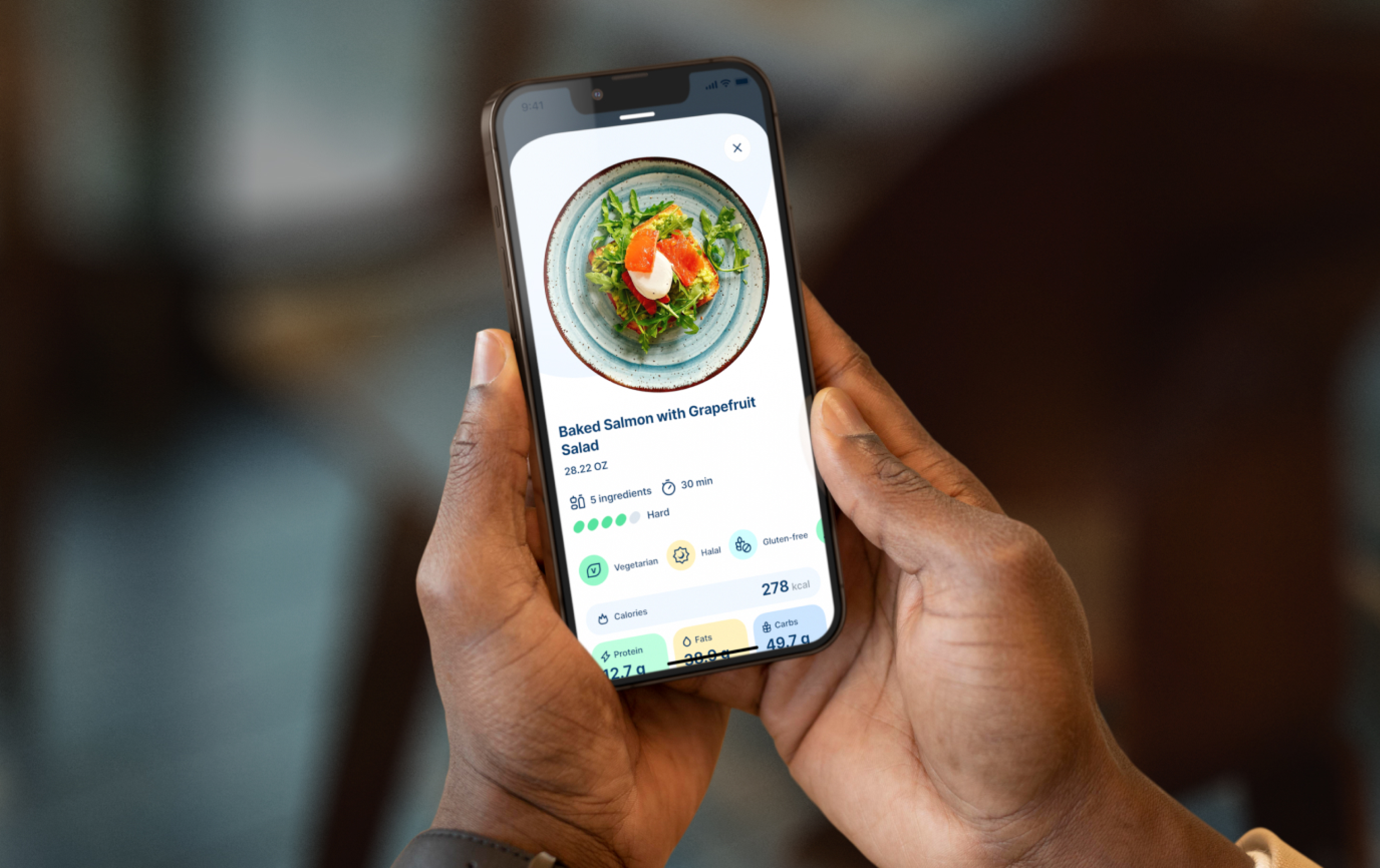 a person holding a mobile phone with the JOKR app opened