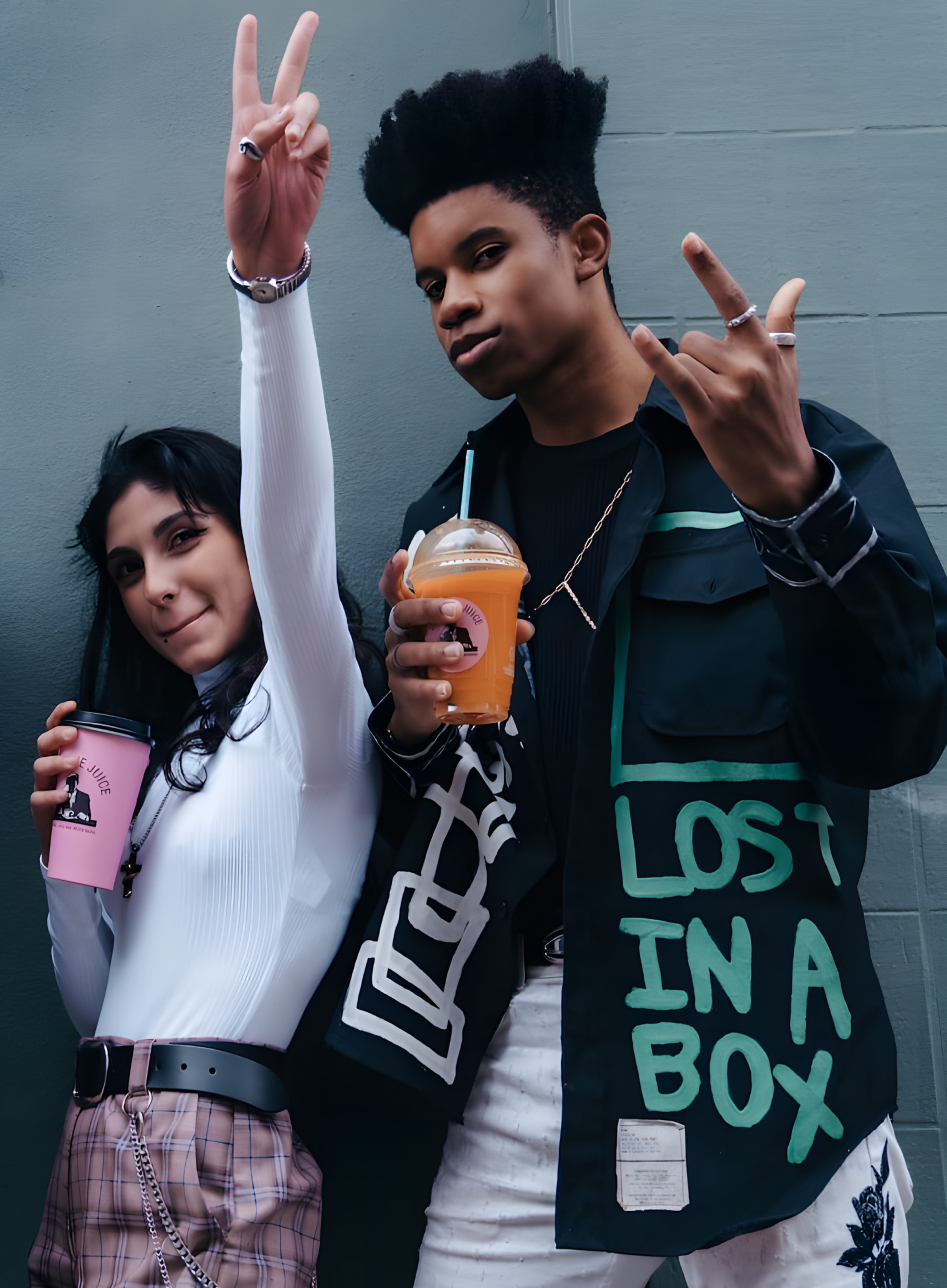 two people standing with the Joe & The Juice cups with beverages