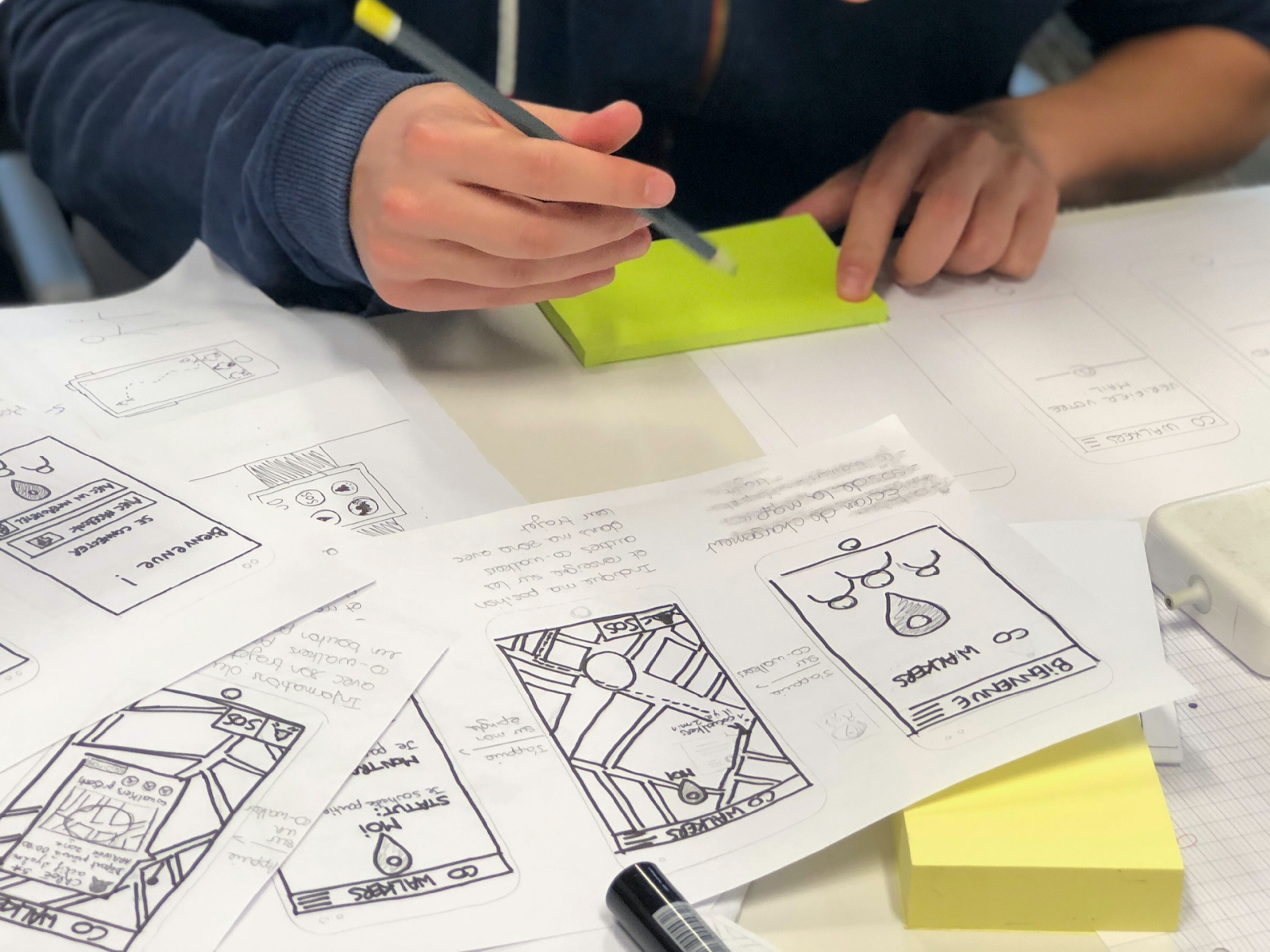 A designer creating paper prototypes