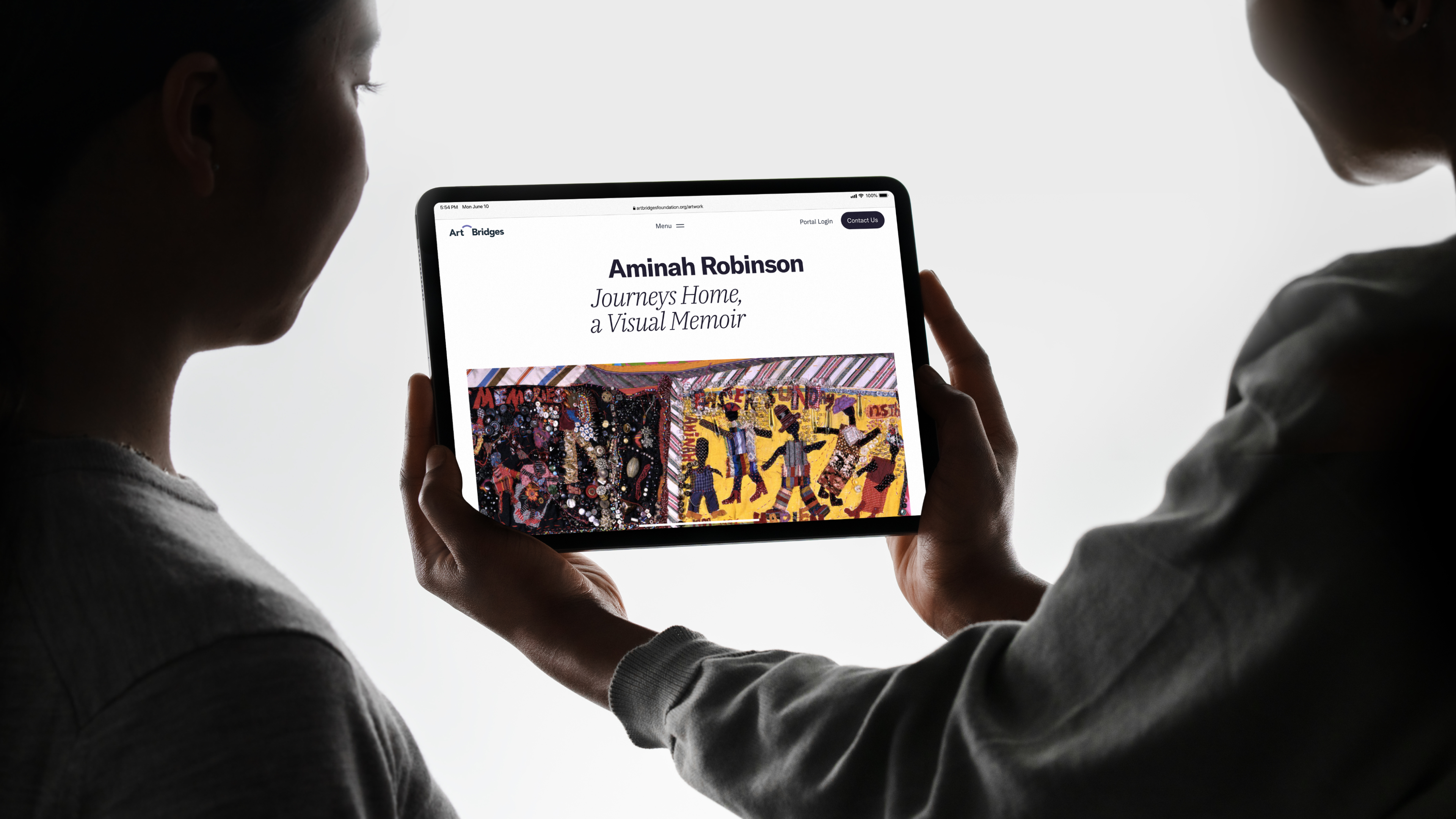 a person holding a tablet with the Art Bridges art card page opened