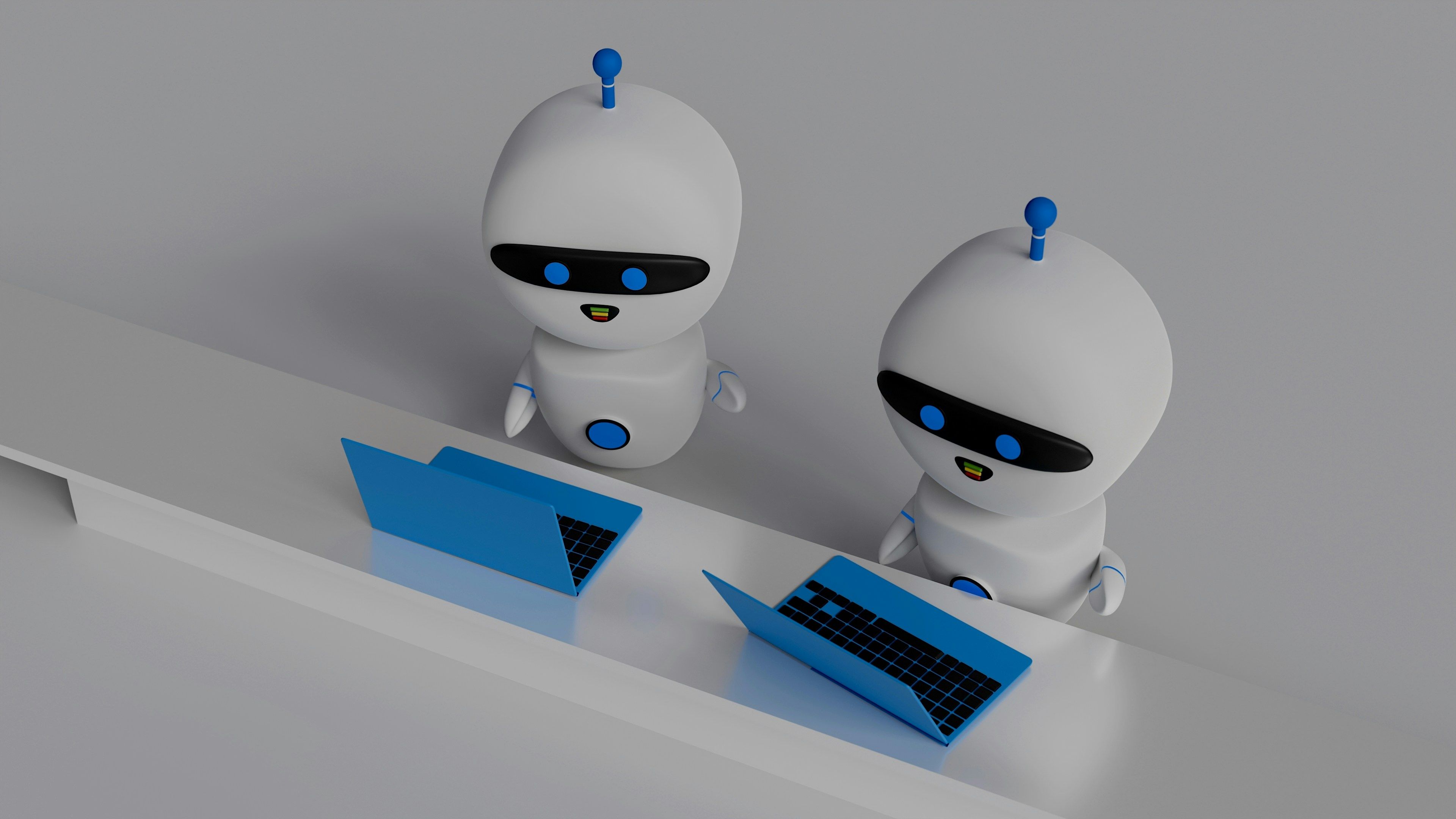 Two 3D white robots using blue laptops