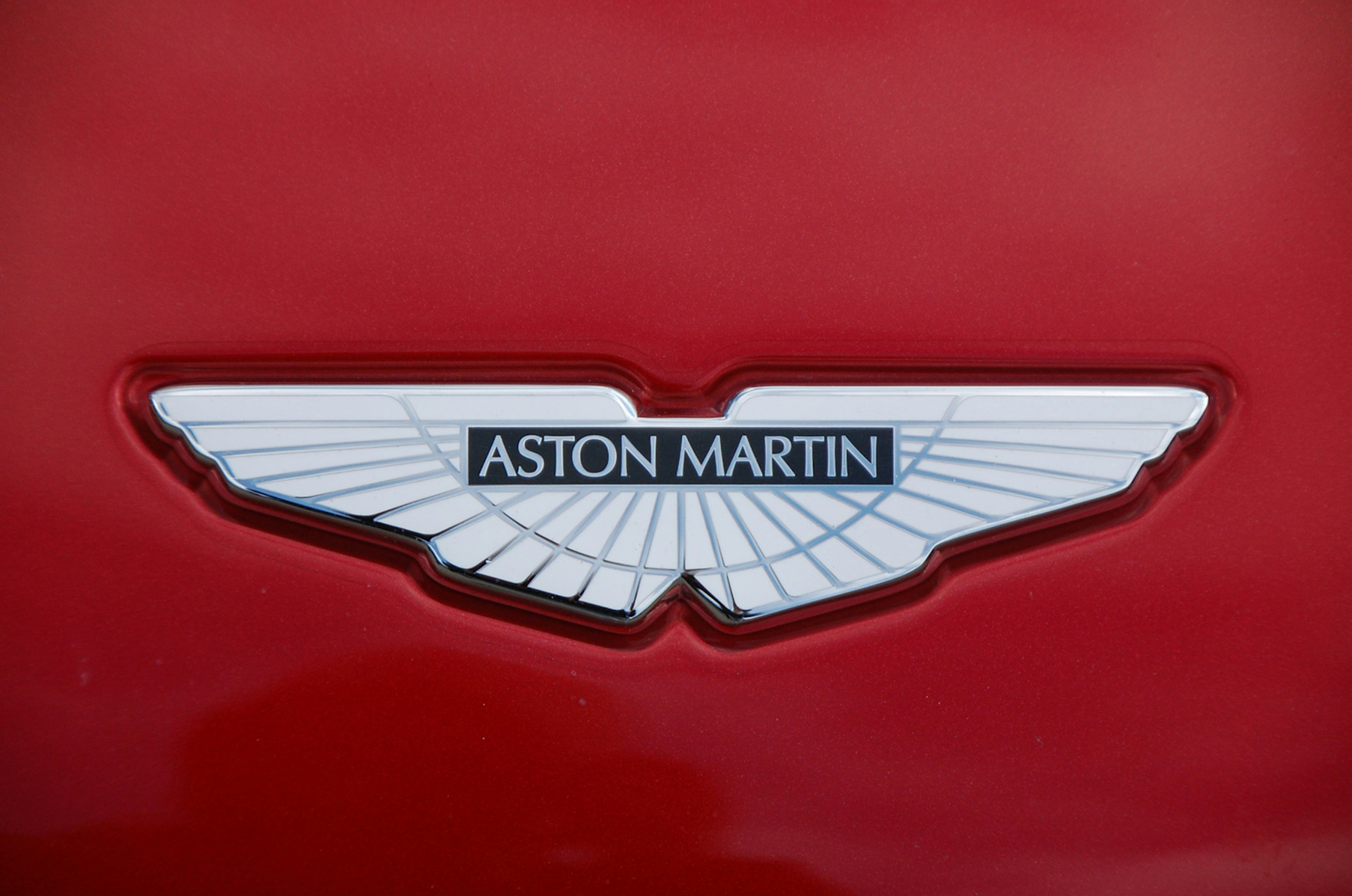 Aston Martin logo: white wings on red background
