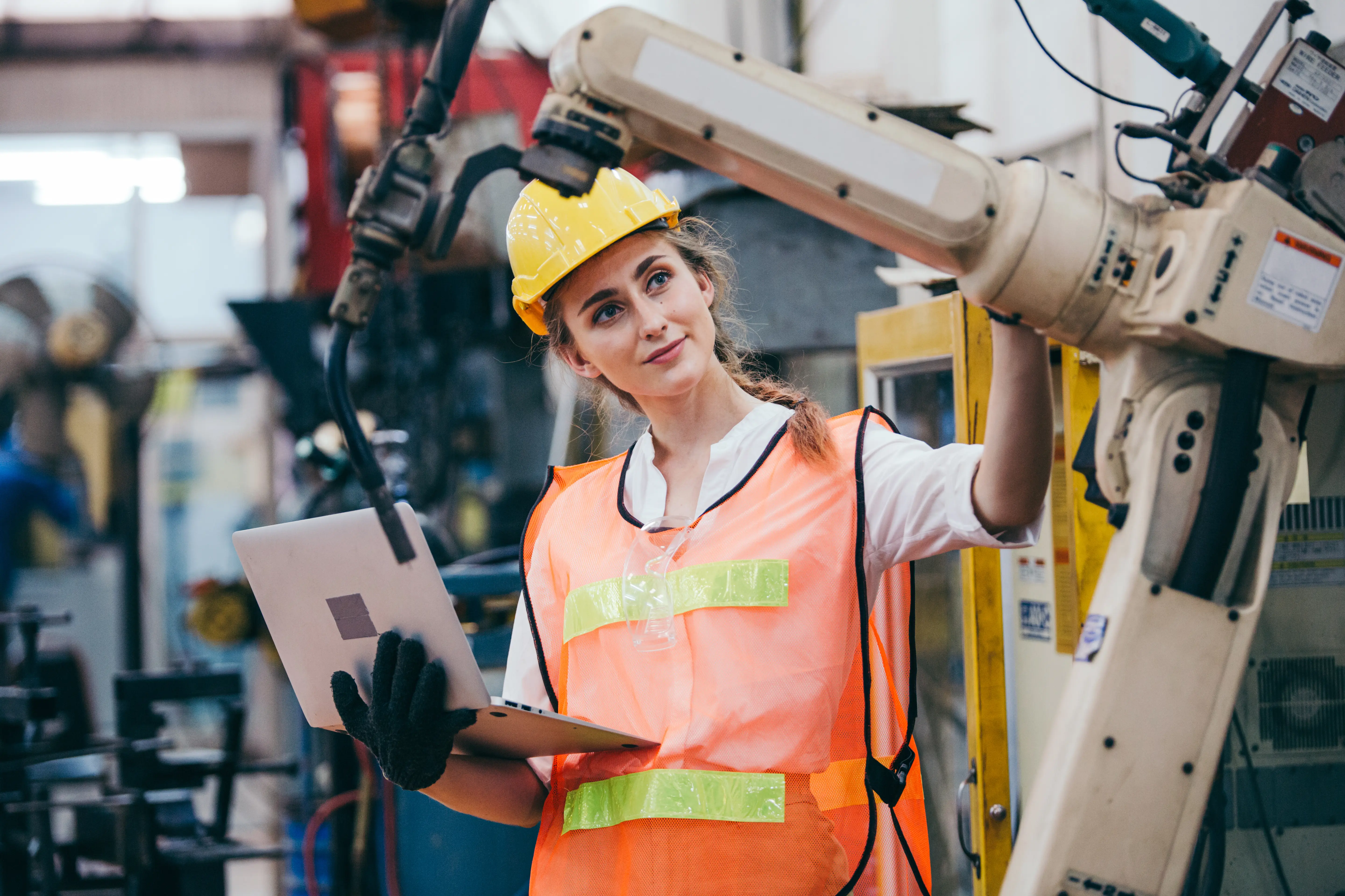 Worker with a computer and machines