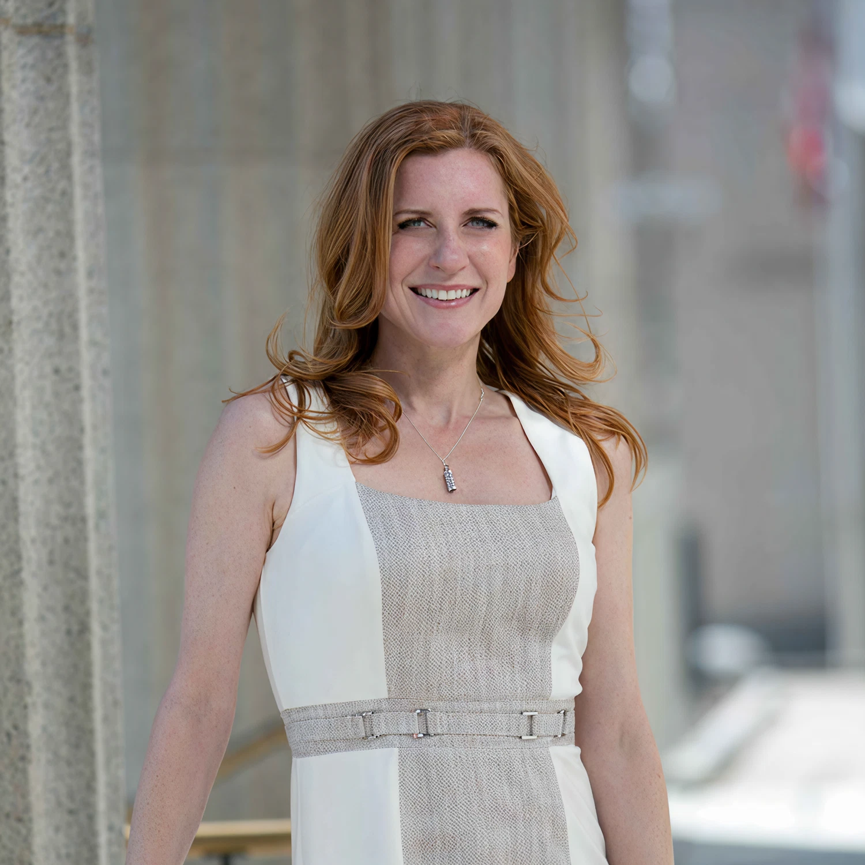 Jessica Worden, Lawhive Co-Counsel in TX & MA, stood outside an office building in a formal business dress