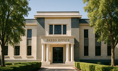 The sunlit facade of a South African Deeds Office building, the official institution where registration of title gives property ownership its binding legal effect.