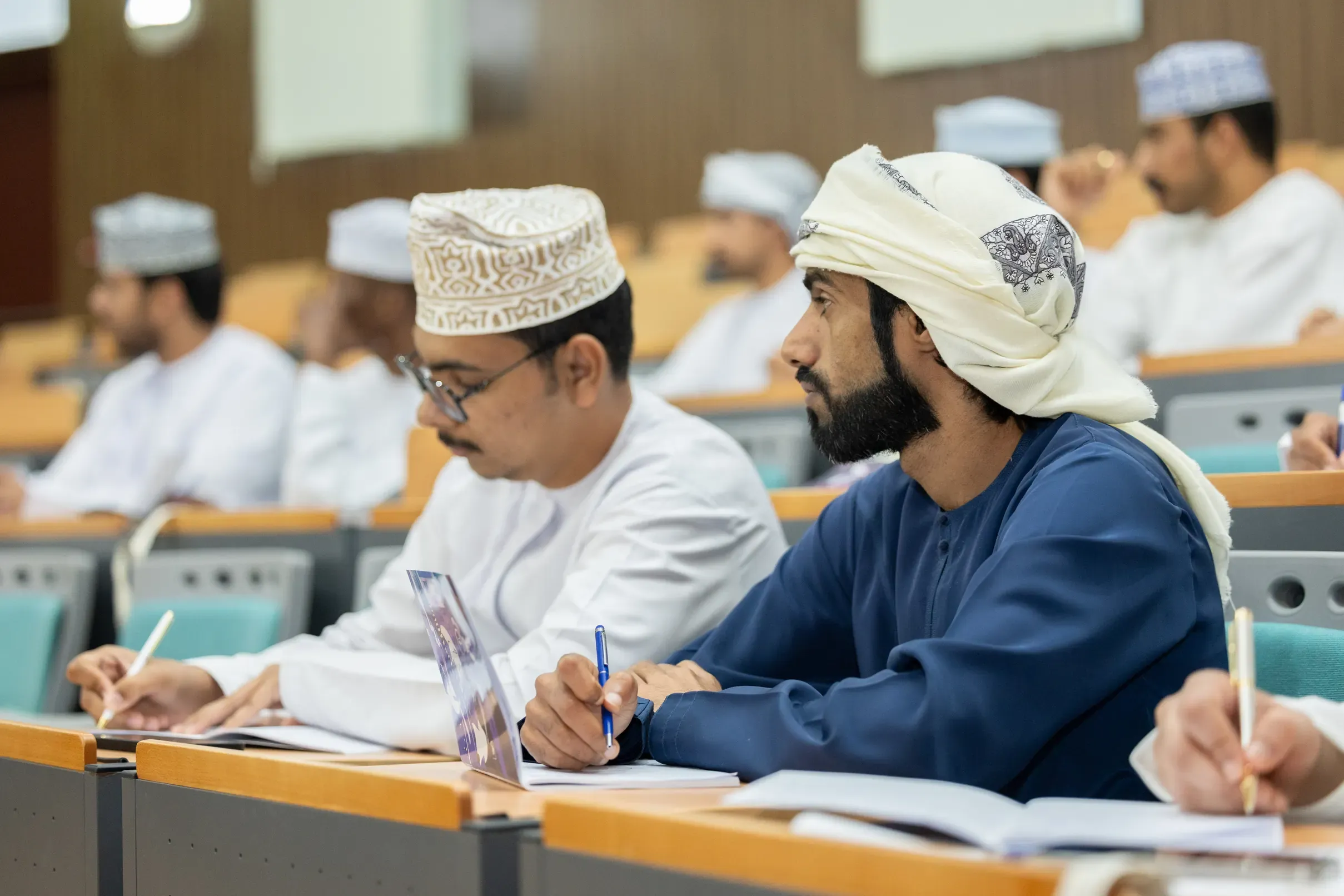 Two students taking notes