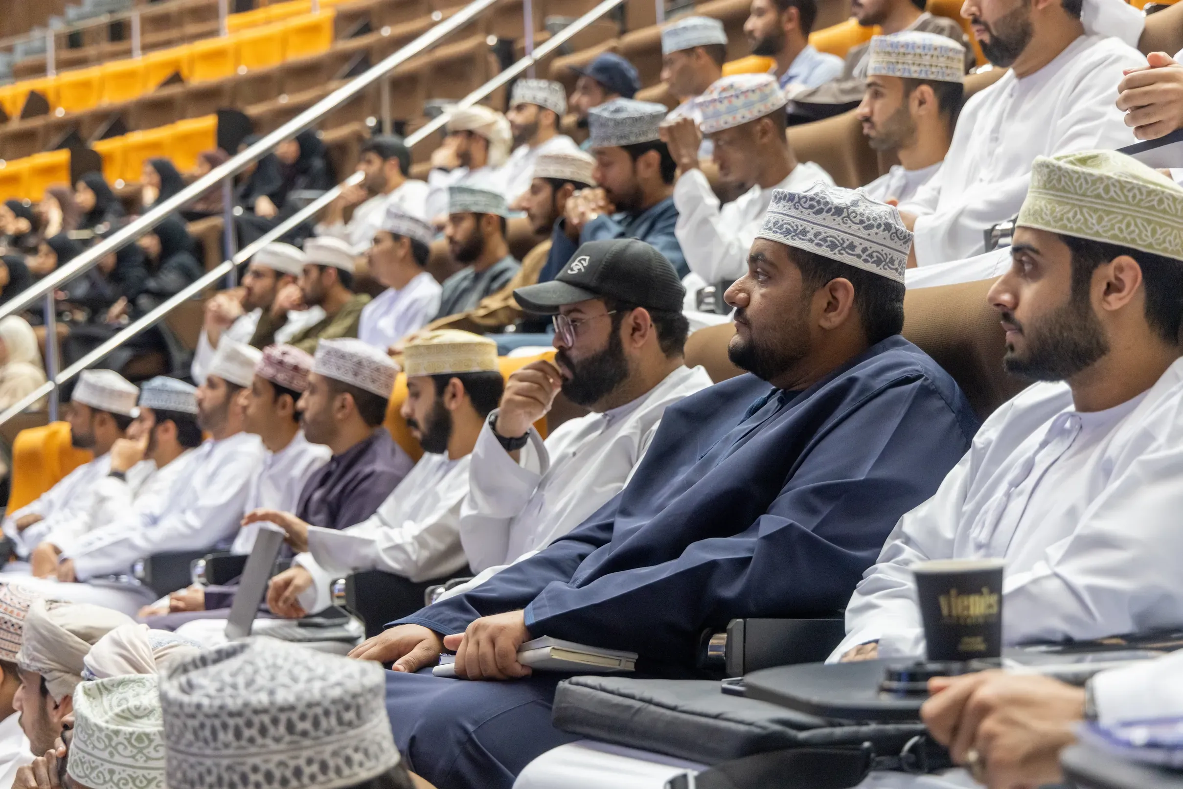 Young men filling the tiers of a lecture hall