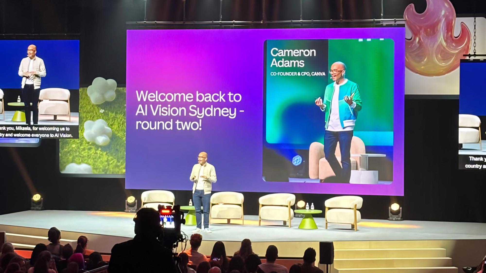 Cameron Adams standing on stage at Canva AI Vision Sydney in August 2026