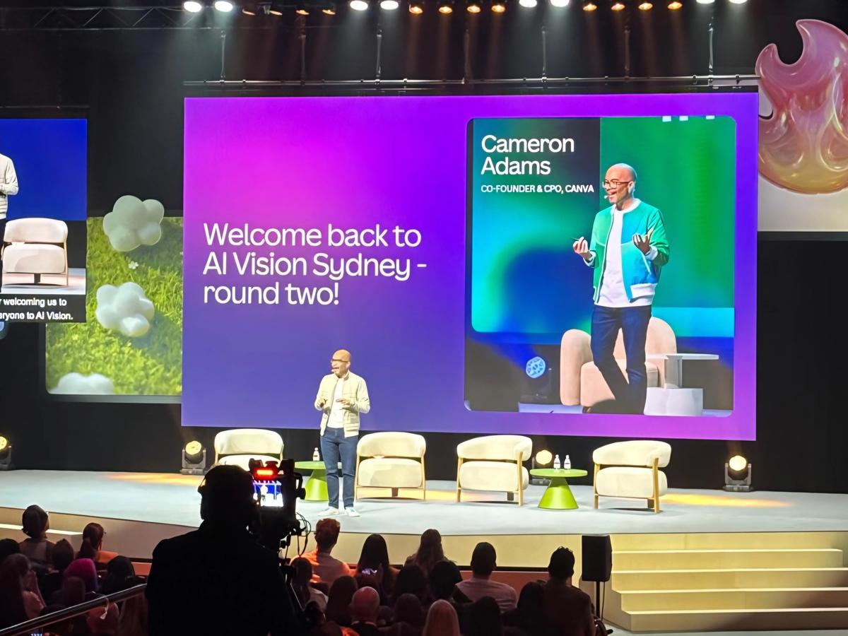 Cameron Adams standing on stage at Canva AI Vision Sydney in August 2026