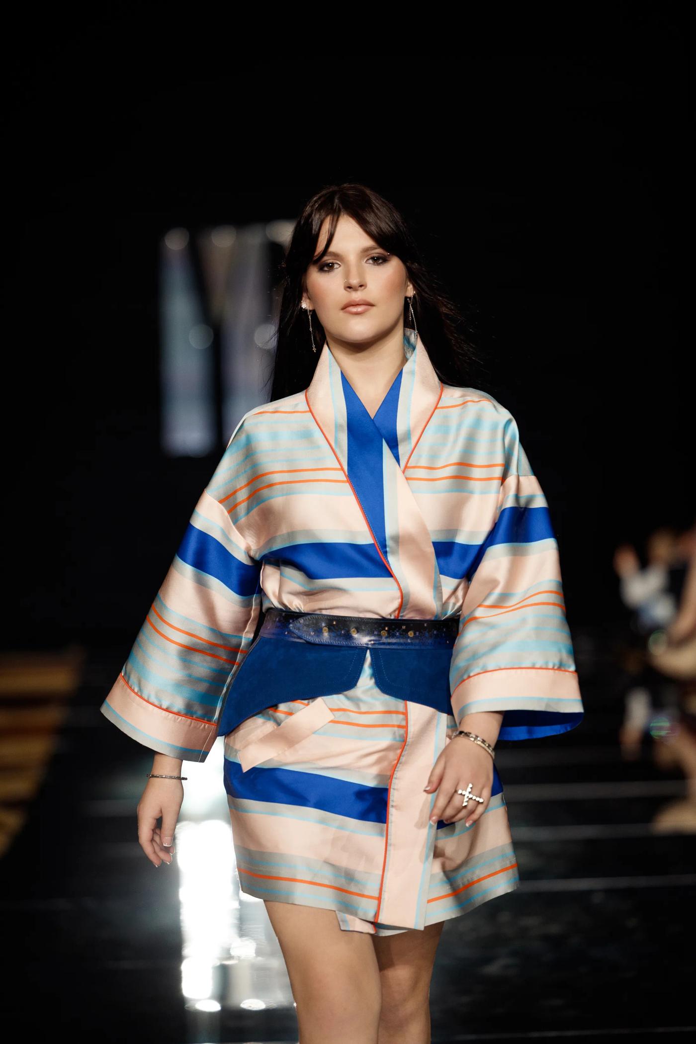 A model in a striped kimono jacket on the YFS runway