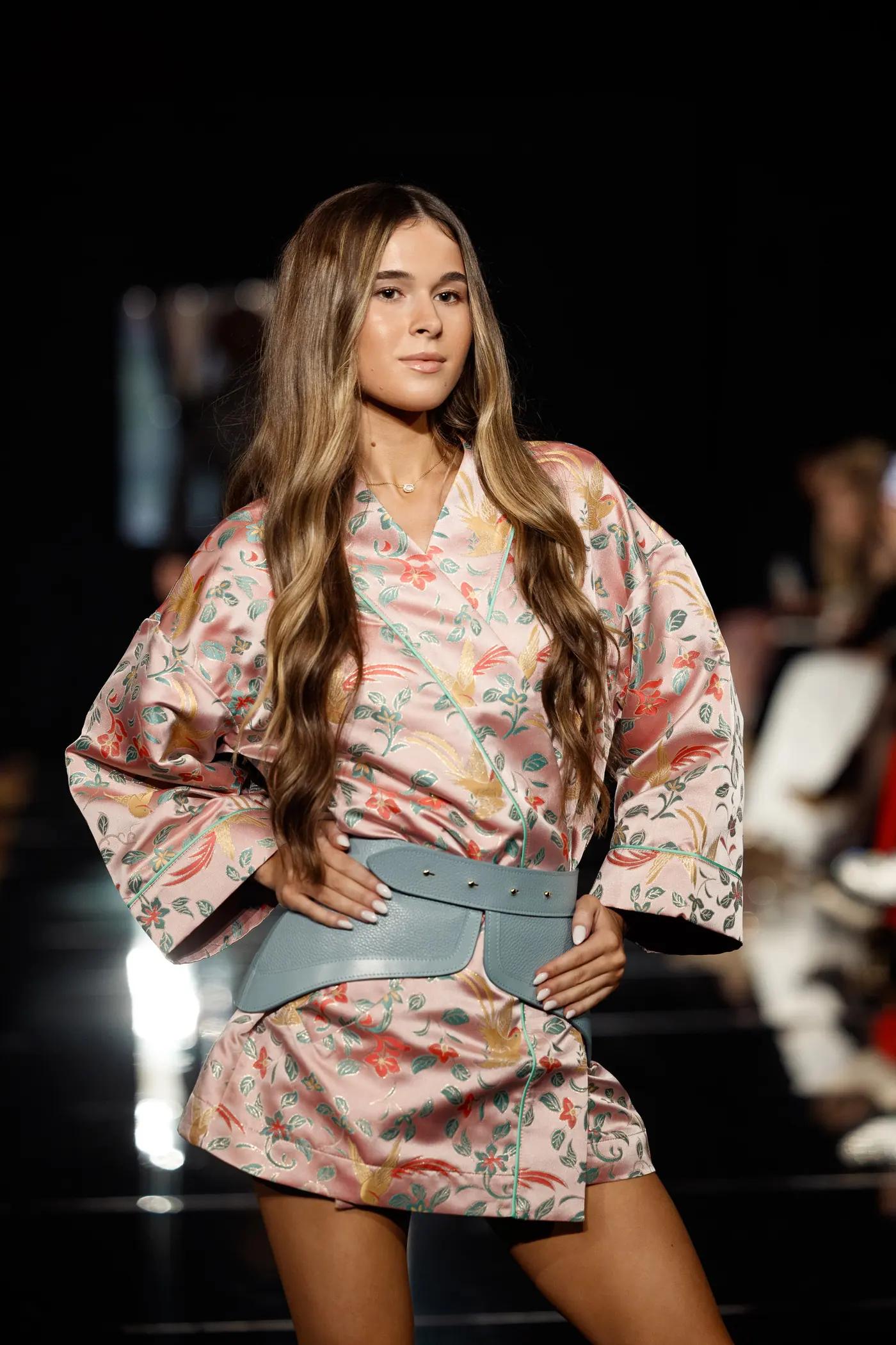 Teen girl walking the runway in a printed set
