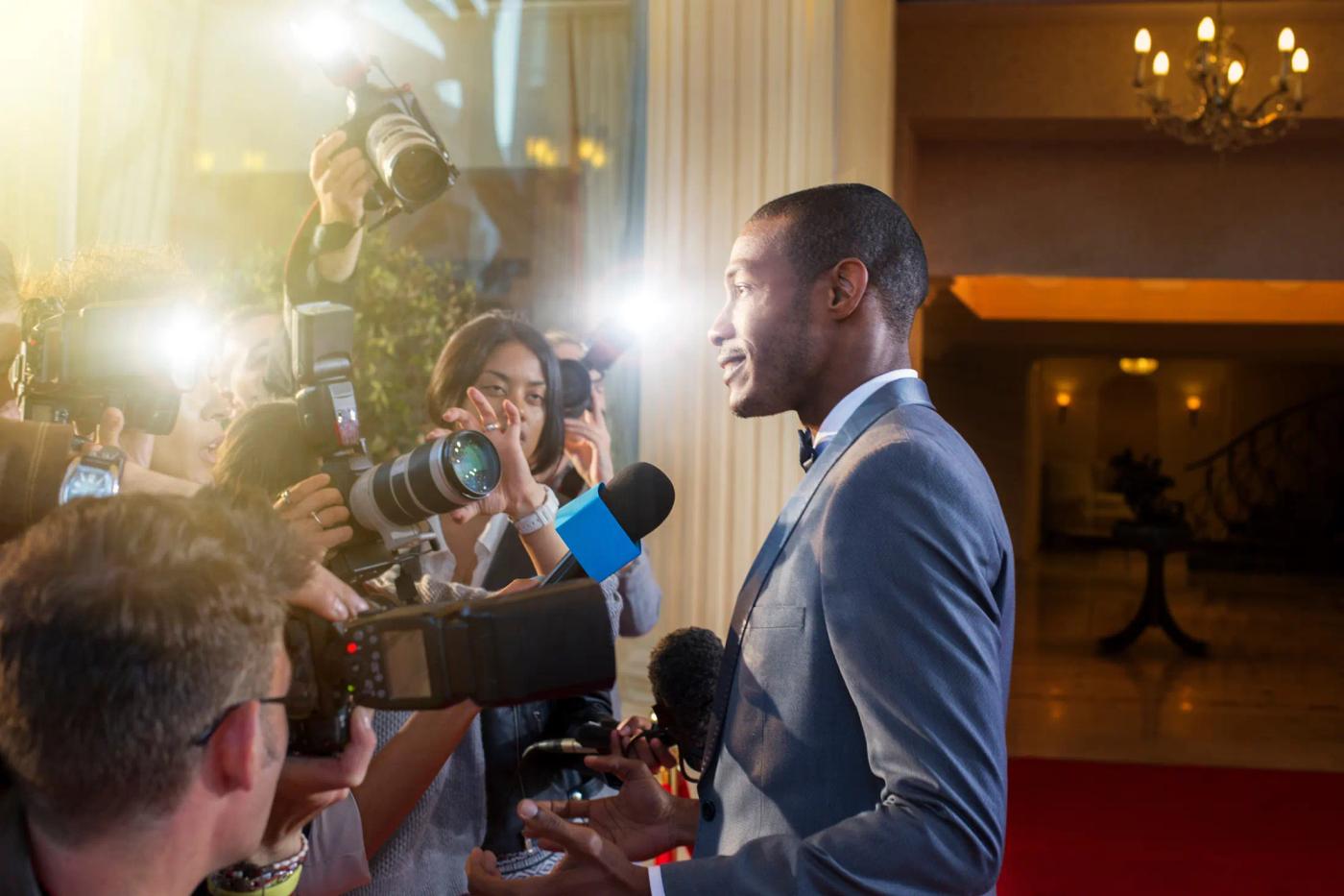 Press photographers and an interview on arrival at a YFS show