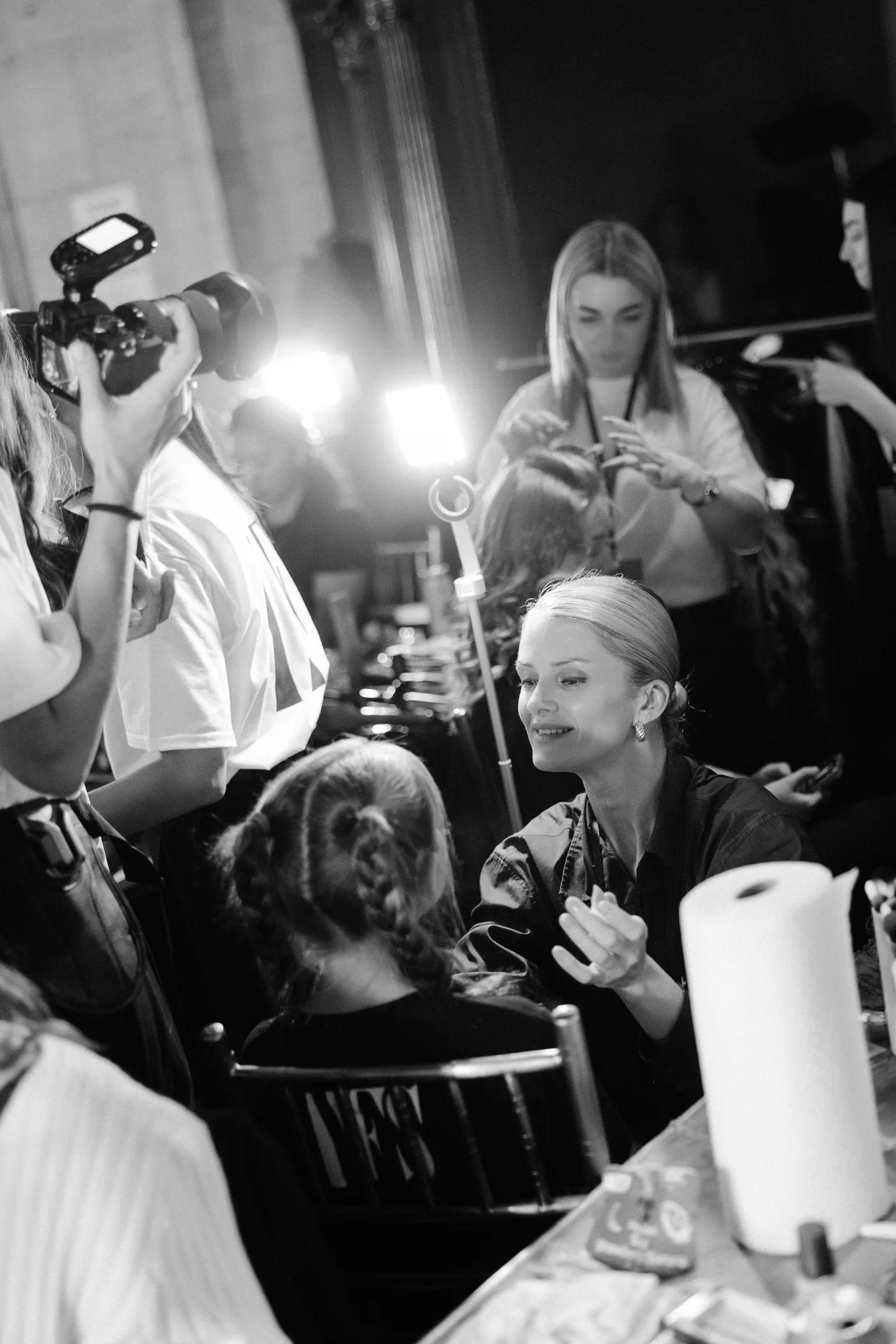 Backstage at YFS: a photographer, stylists and participants getting ready before the show
