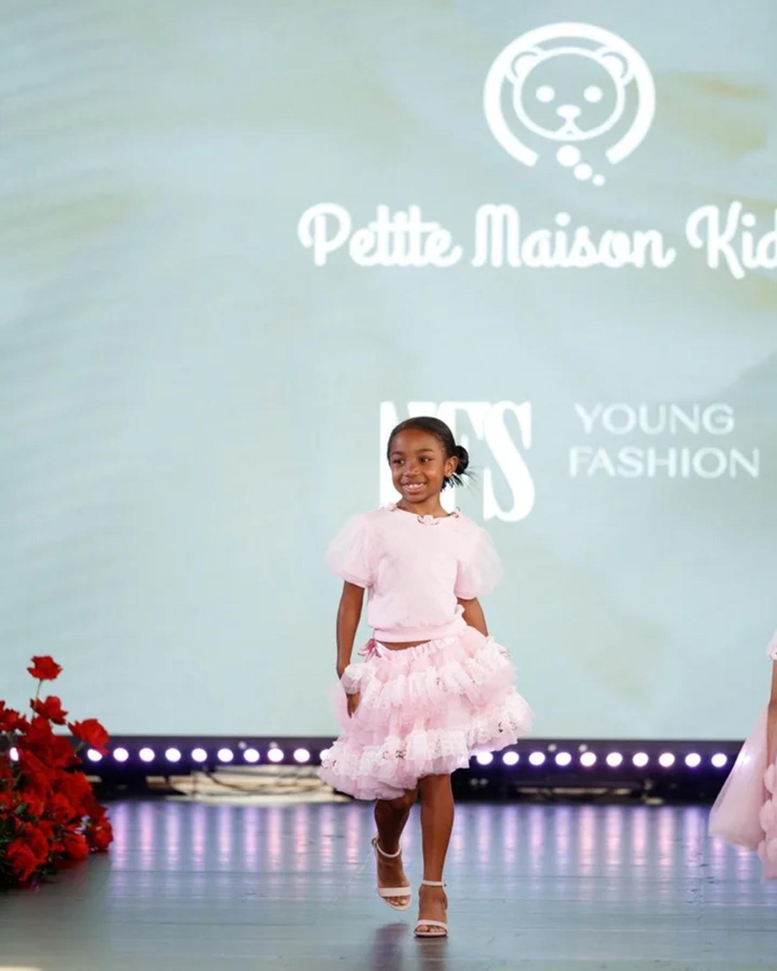 A young model in Petite Maison Kids on the YFS runway