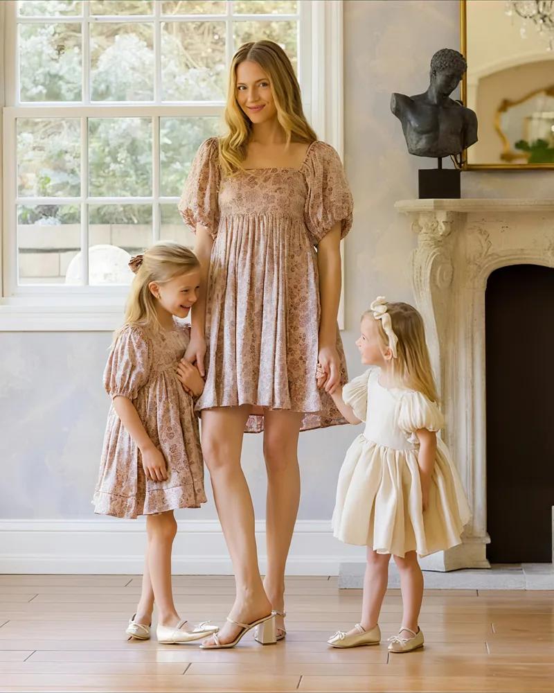 A mother and two daughters in coordinated Mini Me and Mama looks