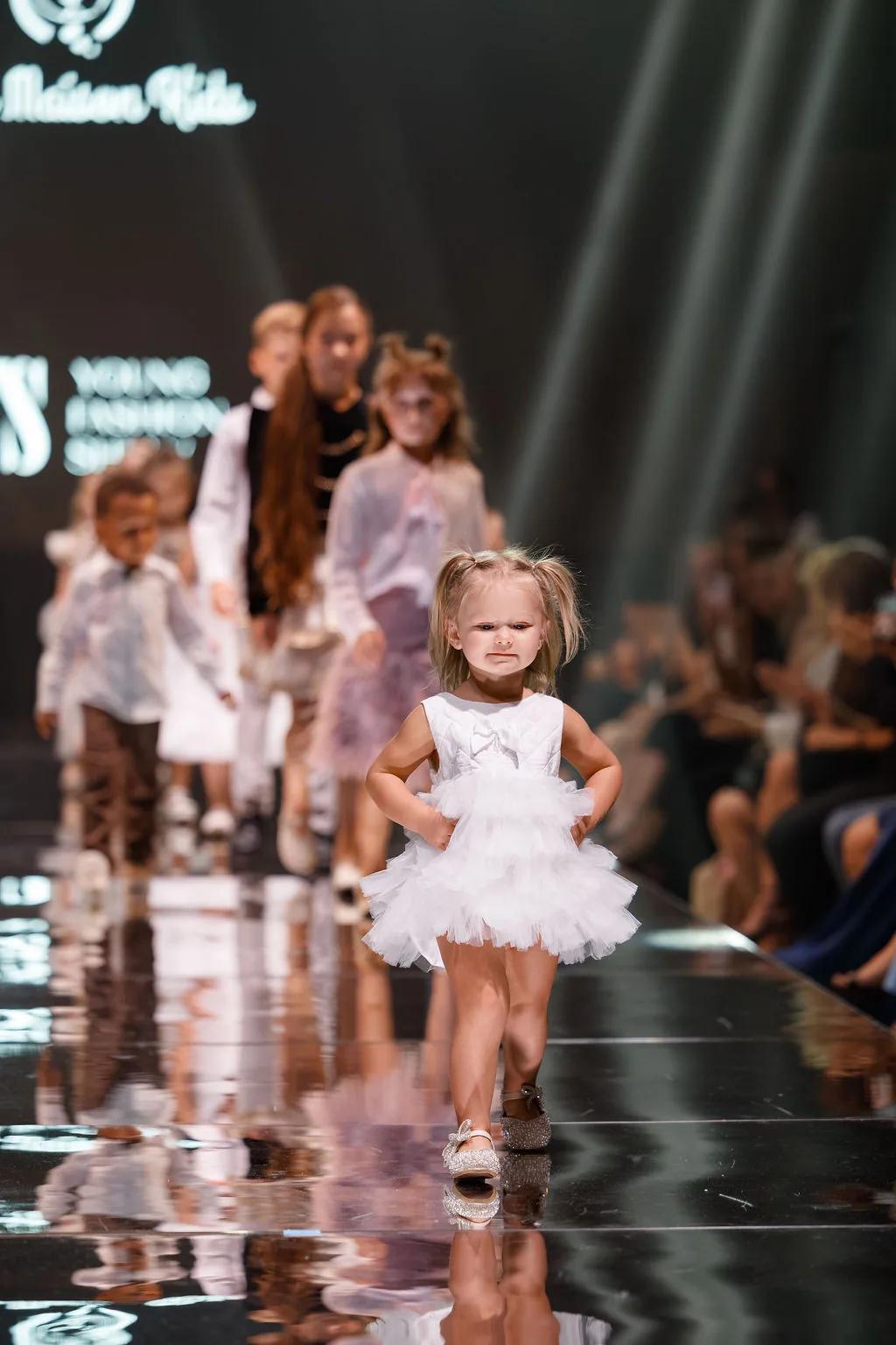 Young children walking the runway