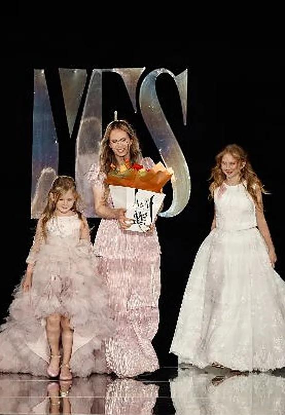 Nadiia Kholina, owner of Mini Me and Mama, on the YFS runway with her daughters