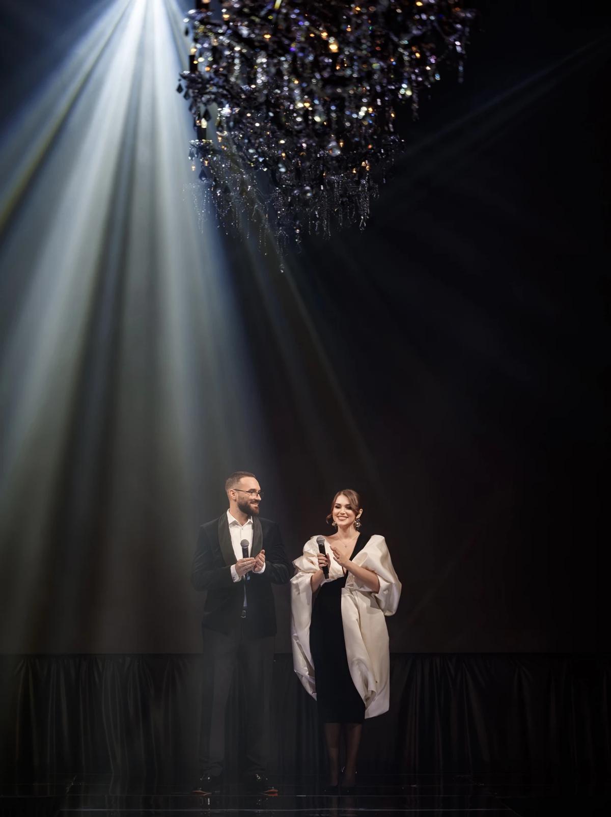 Diana Hetun and Taras Lavrovskyi on stage at a fashion event
