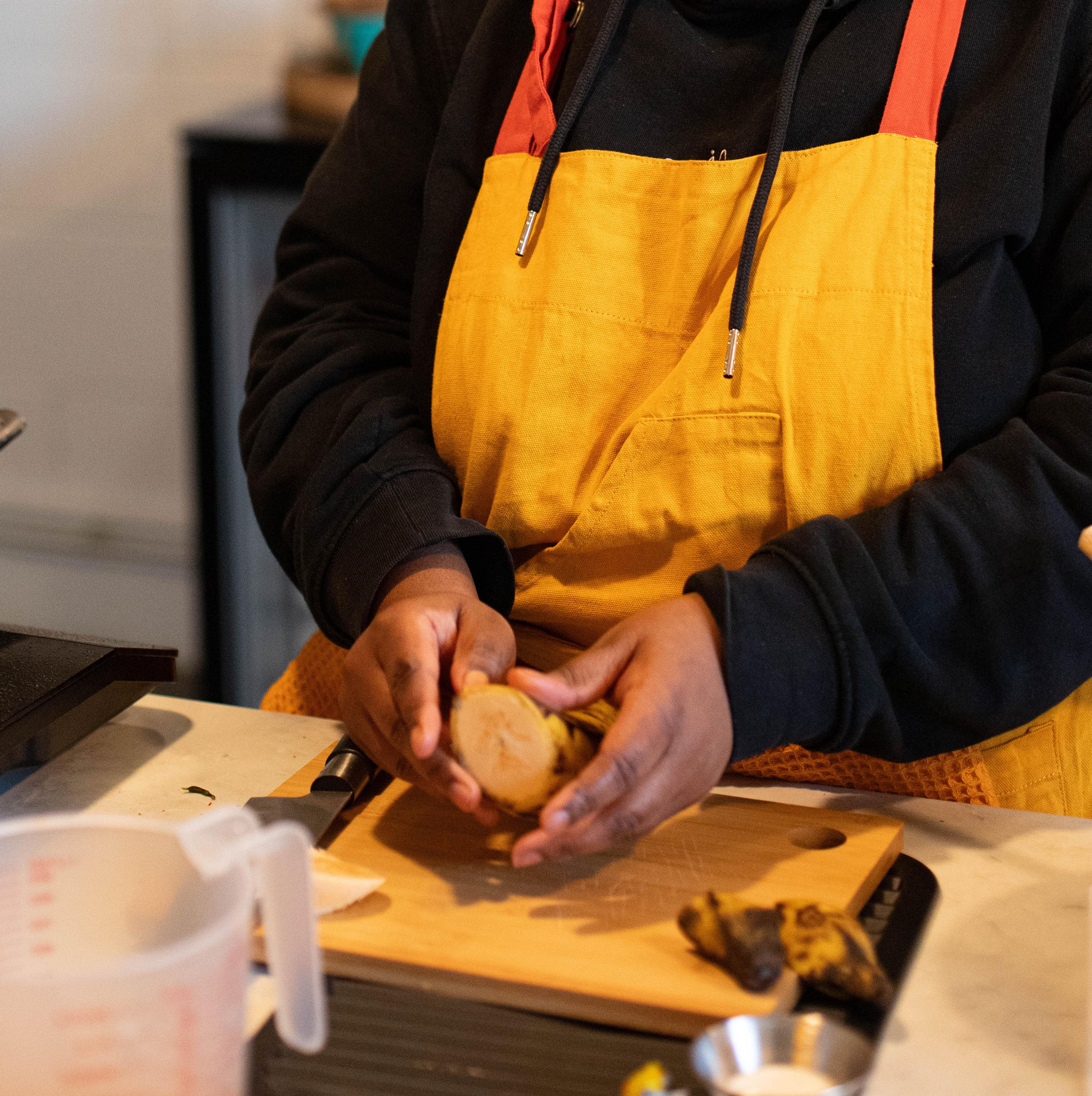 Hands working with West African ingredients