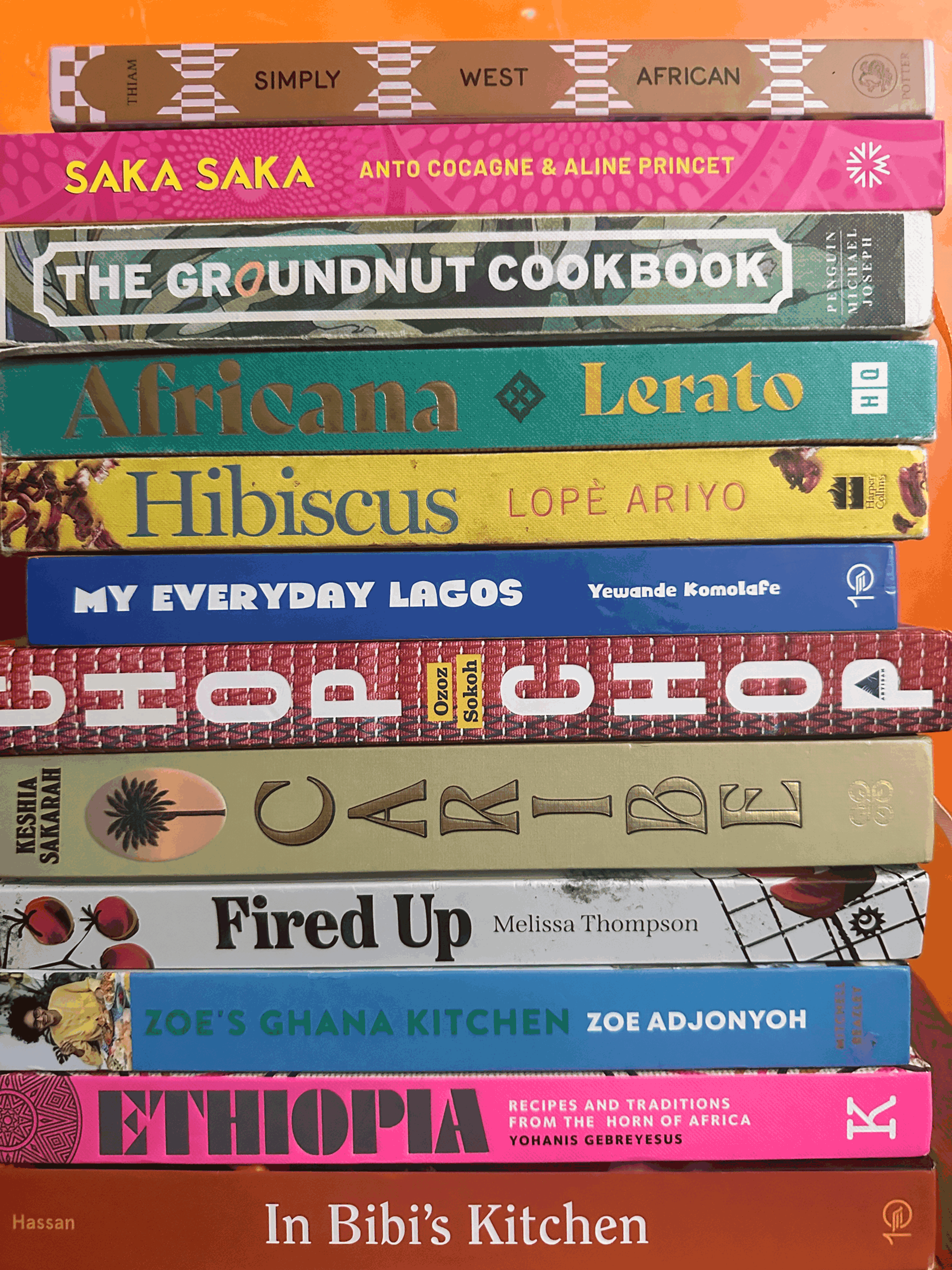 A stack of African and Caribbean cookbooks, spines facing out