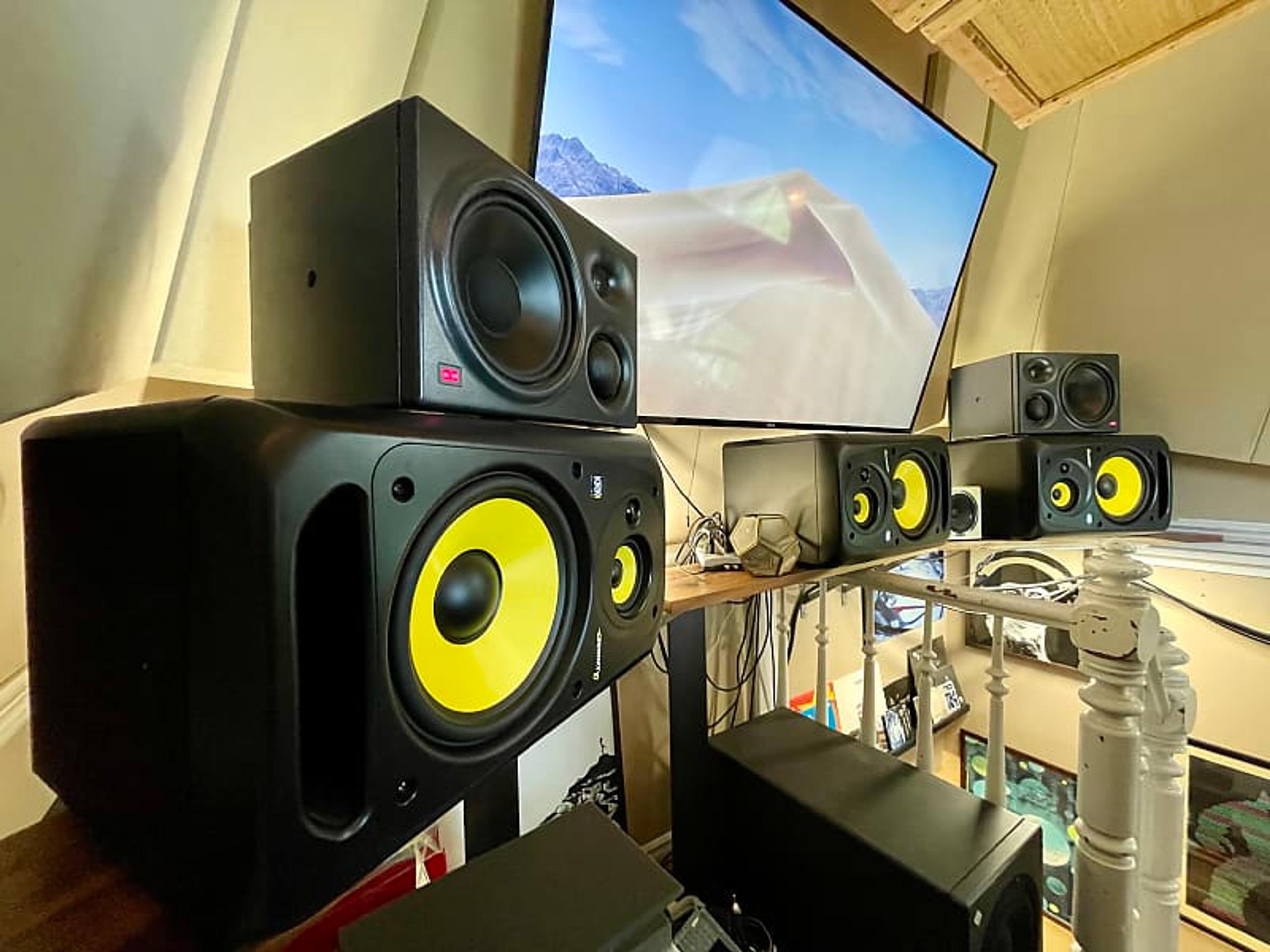 A person mixing music in a home studio with KRK Rokit studio monitors