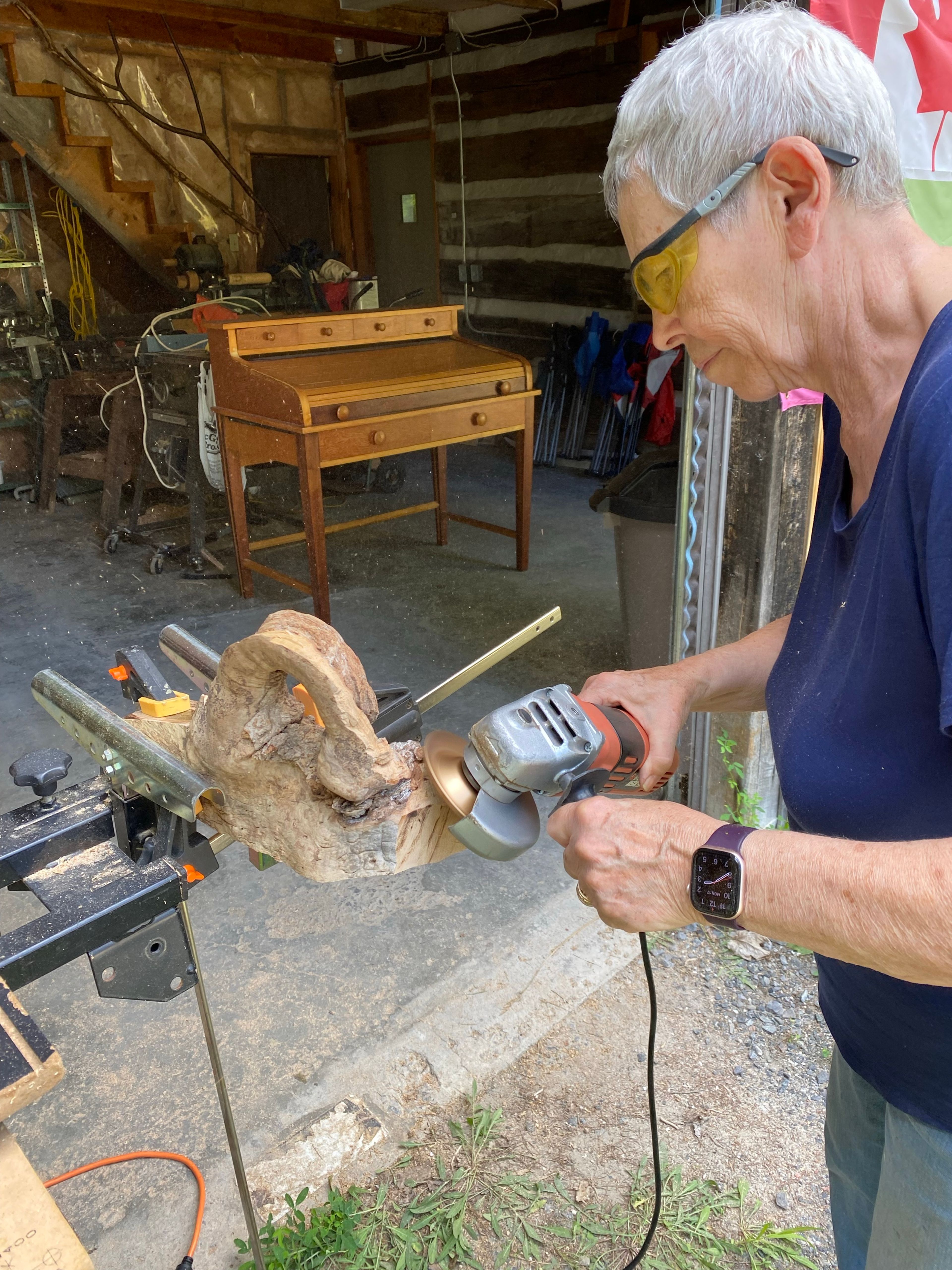 Gloria Lee-Shoebridge working on a wood sculpture in her studio