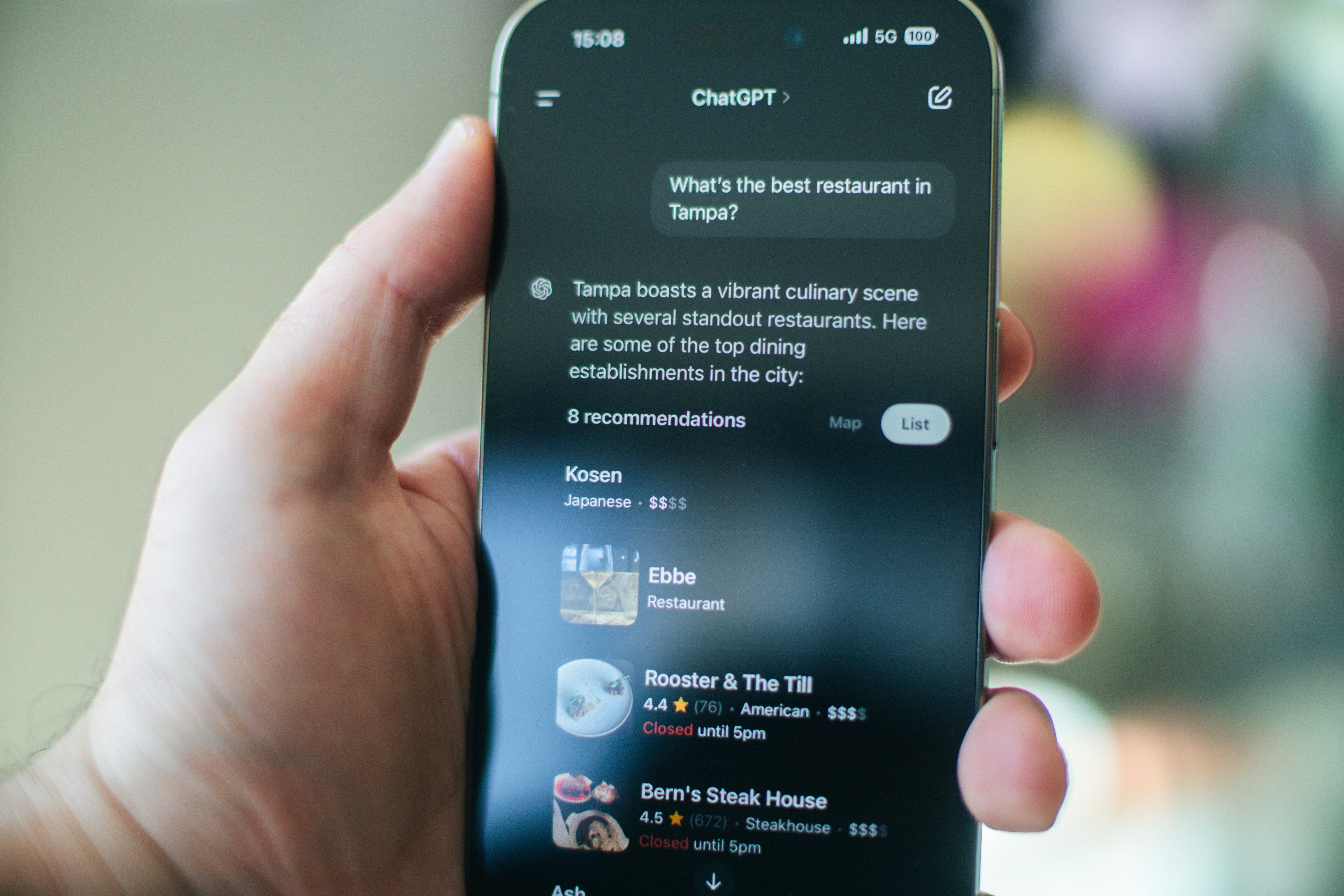a person holding phone with chatgpt results in the screen