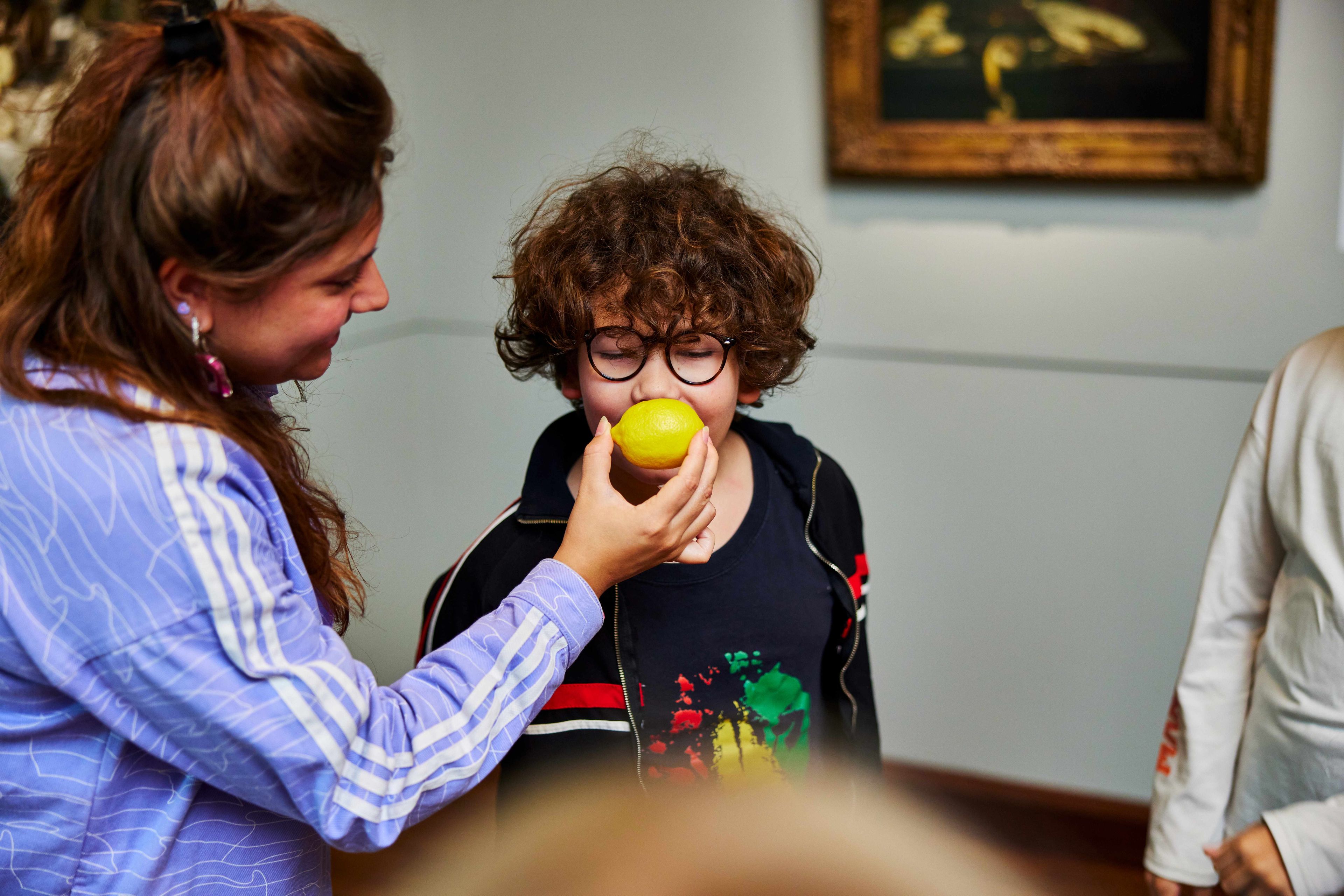 Child bites into lemon at education programme paint, story, fantasy.