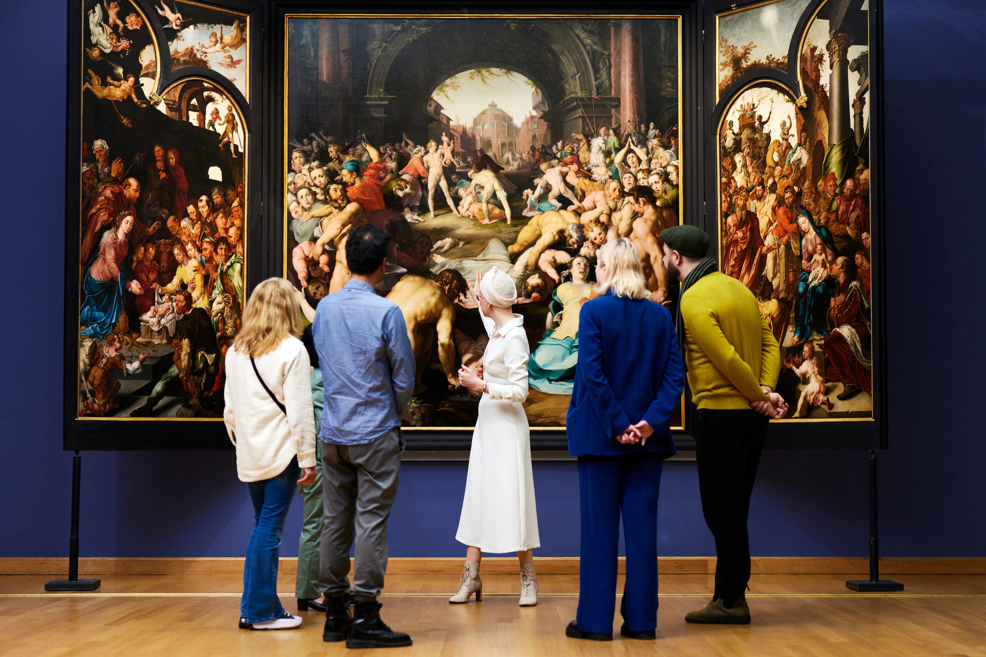 Tour guide talking to visitors at the museum.