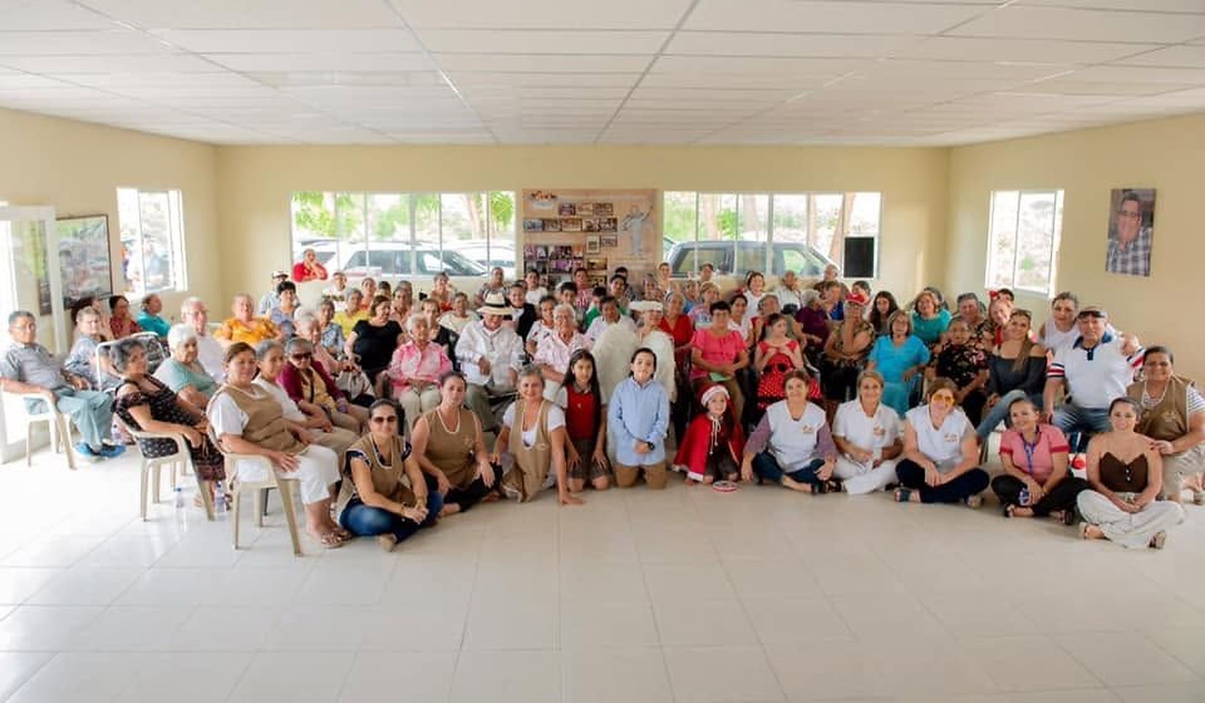 Gran grupo de adultos mayores, familias y voluntarios en una celebración de FUNADELÁN