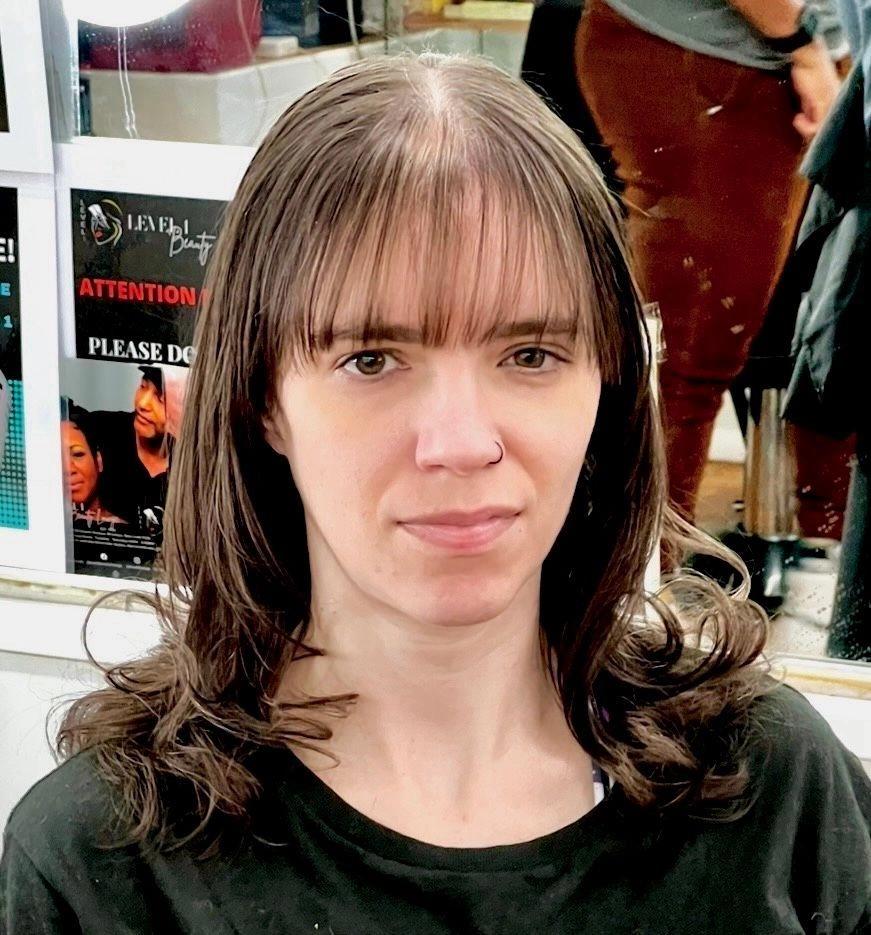 Long layered brunette haircut with bangs and curled ends