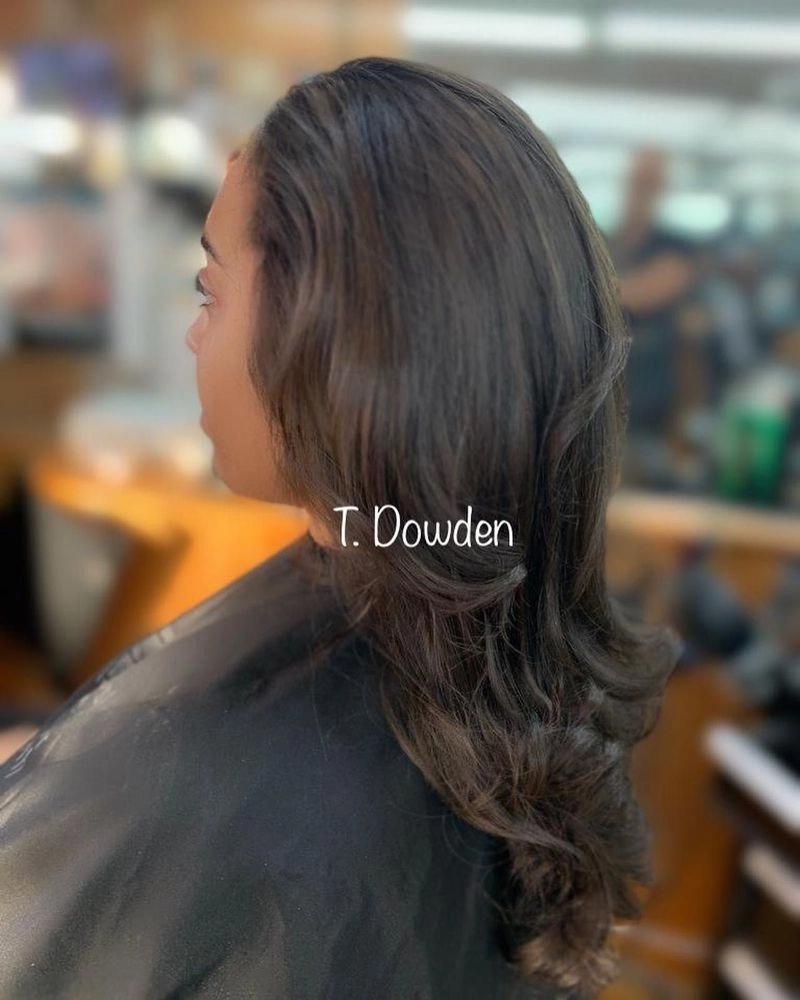 Long layered dark brown hair with curled ends