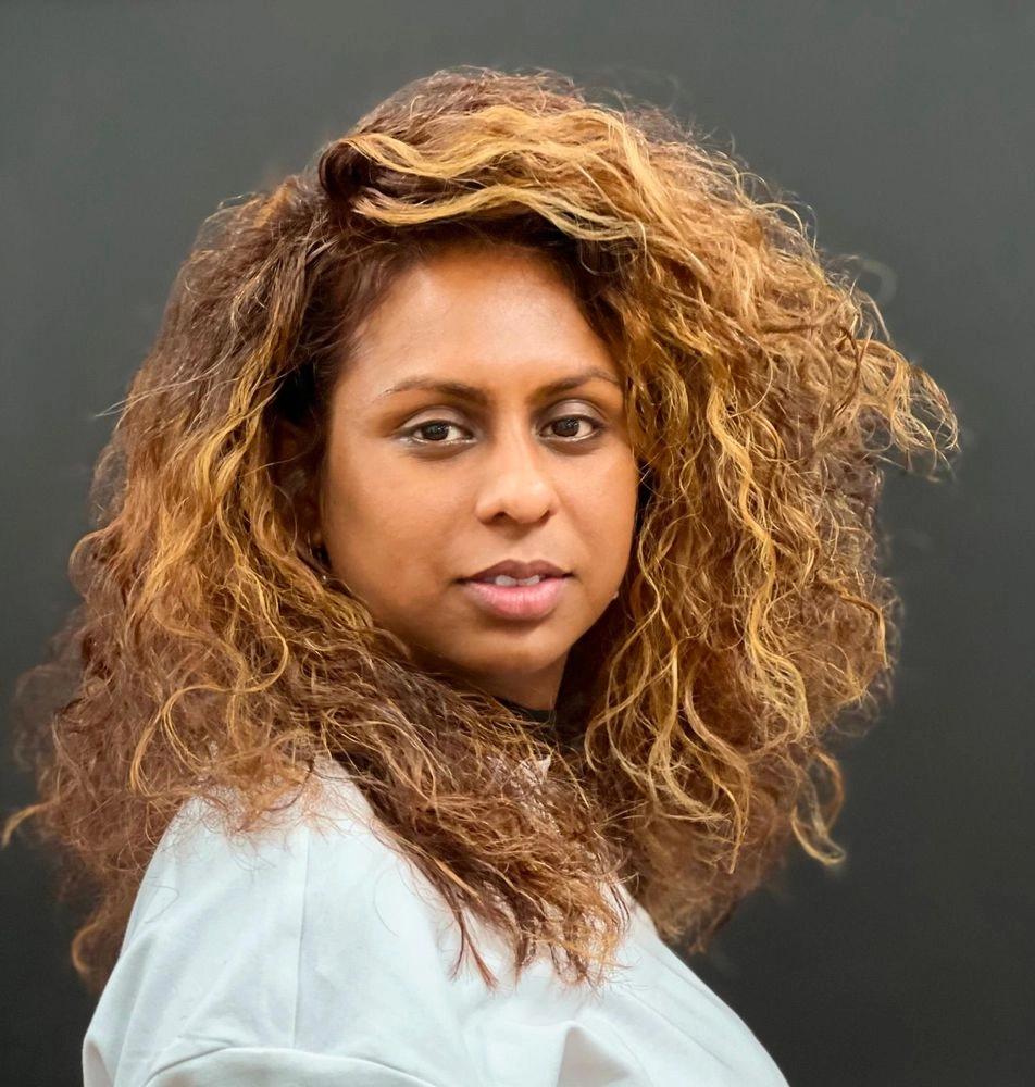 Long curly hair with honey-blonde balayage