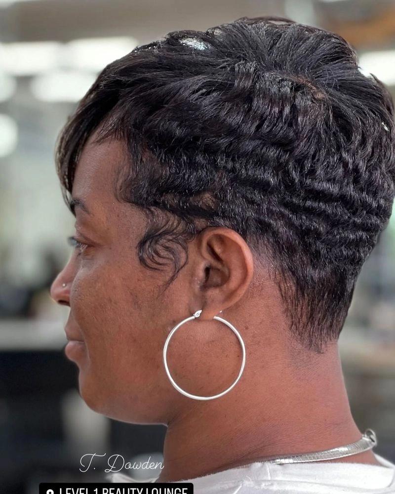 Short black pixie cut with finger waves, seen from the side