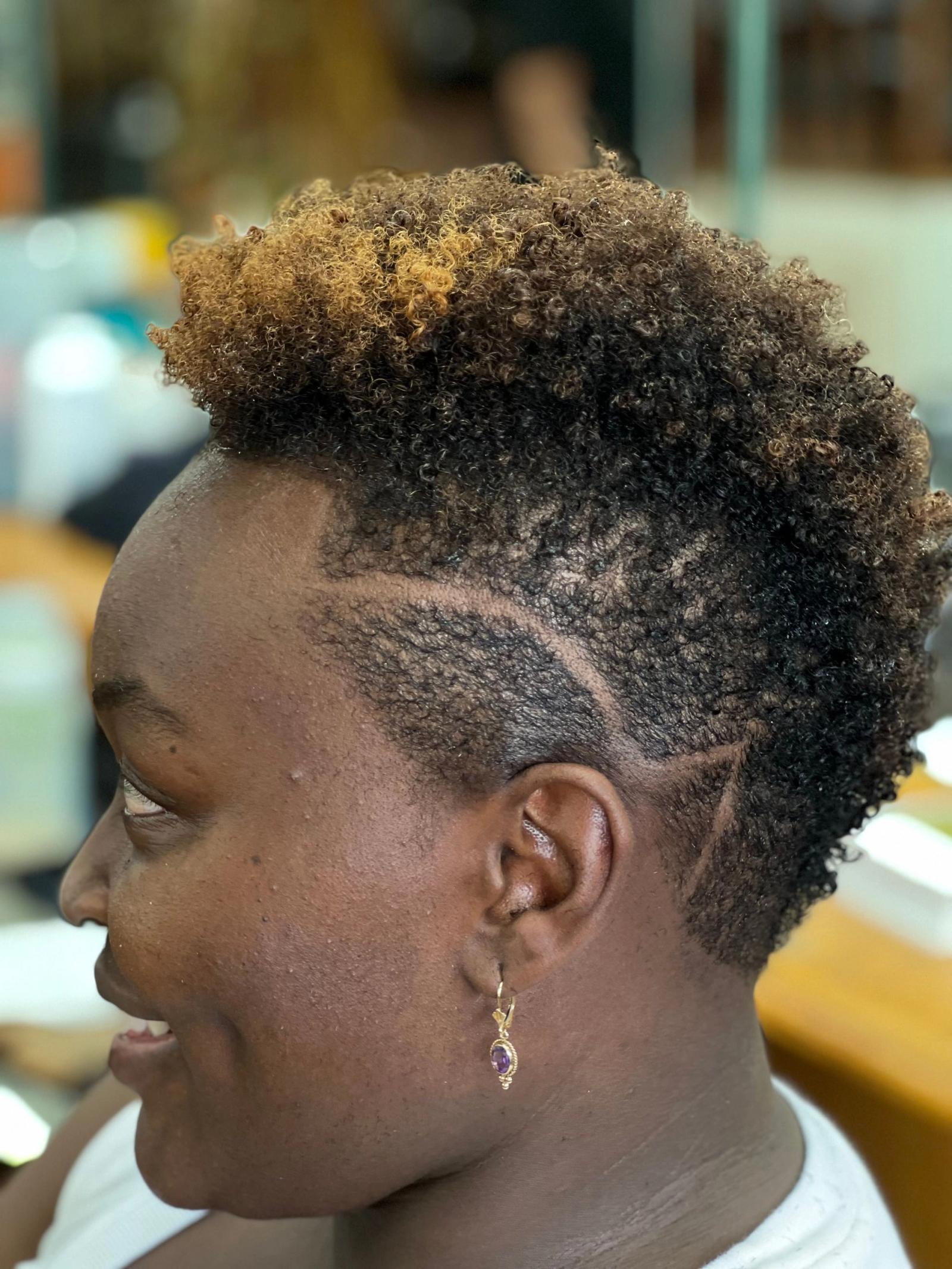 Tapered mohawk with a curly top and design lines