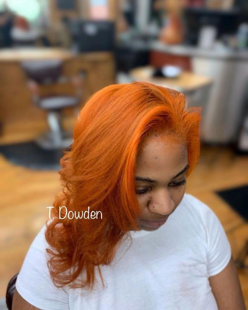 Long straight hair in a copper-orange color, finished look