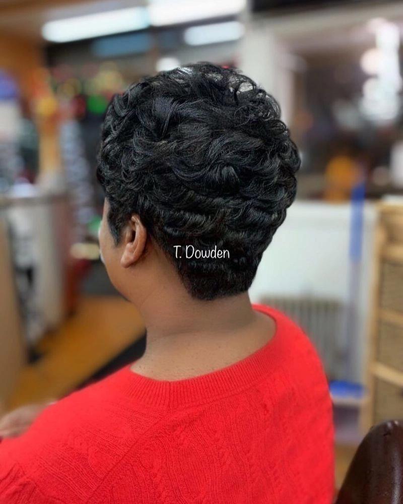 Short black pixie cut styled with finger waves