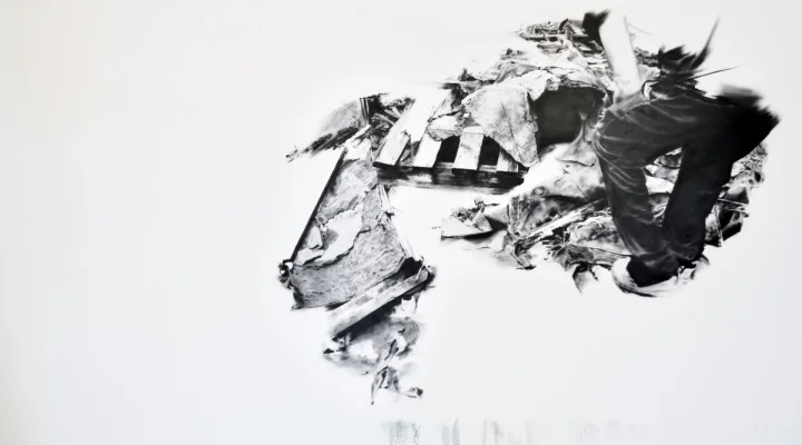 Black gestural forms and fragmented imagery on a white ground.