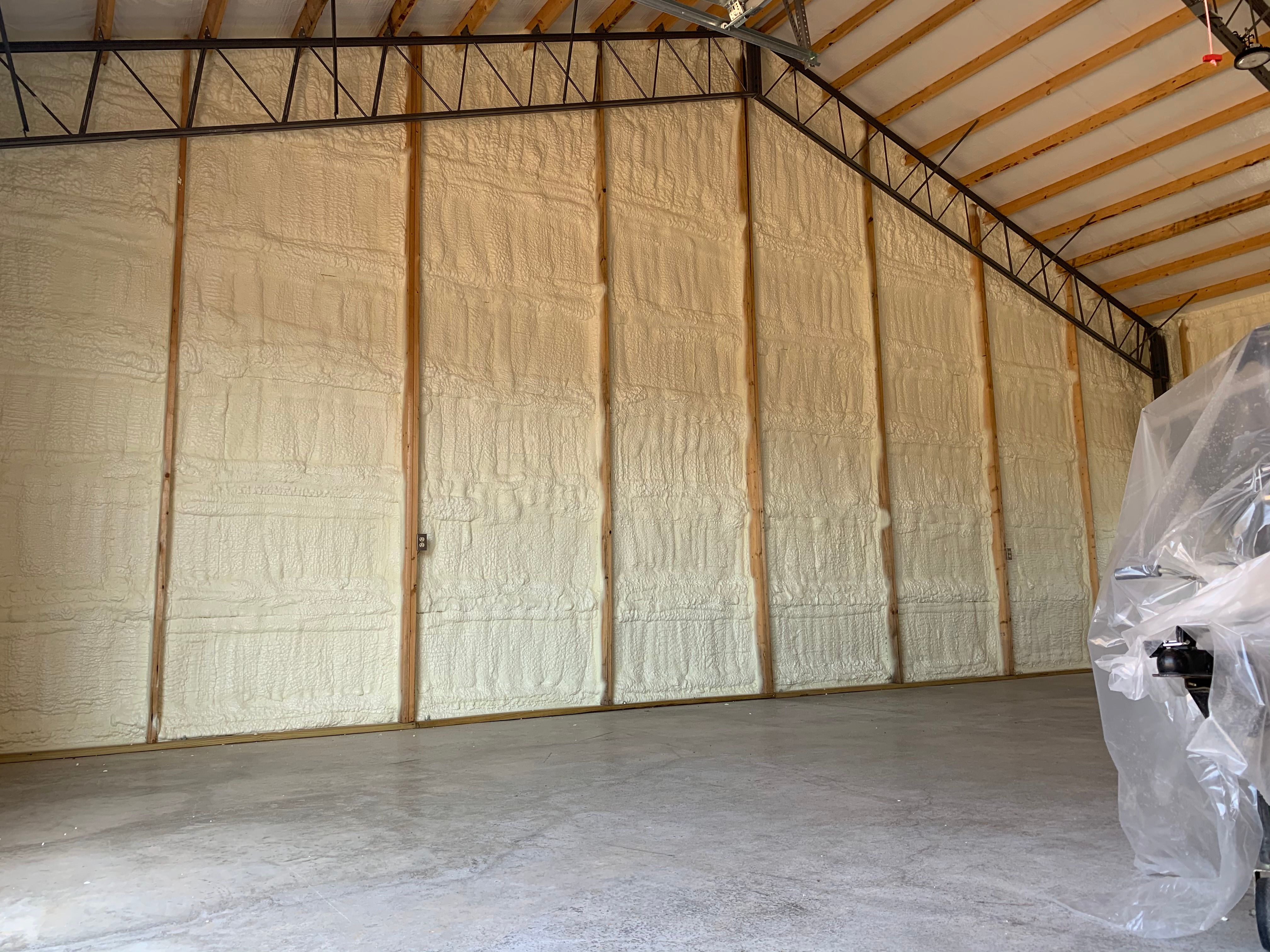 Spray foam insulation on the high walls of a metal building shop near Pea Ridge, Arkansas
