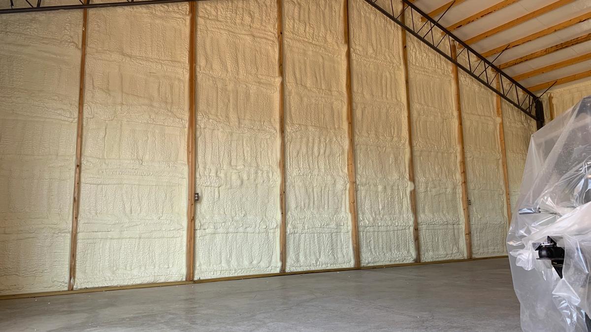 Spray foam insulation on the high walls of a metal building shop near Pea Ridge, Arkansas
