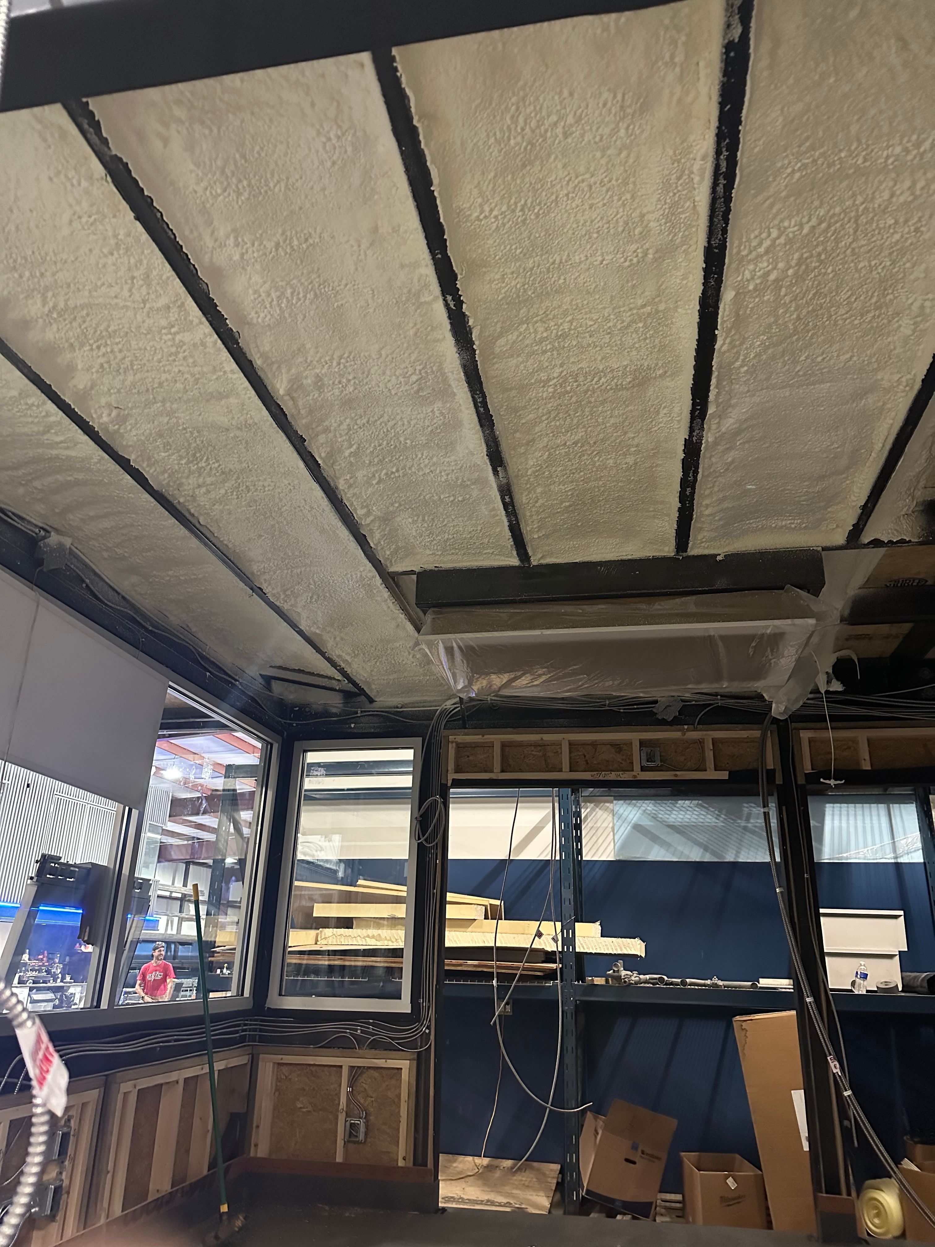 Open cell spray foam insulation in a commercial interior during build-out