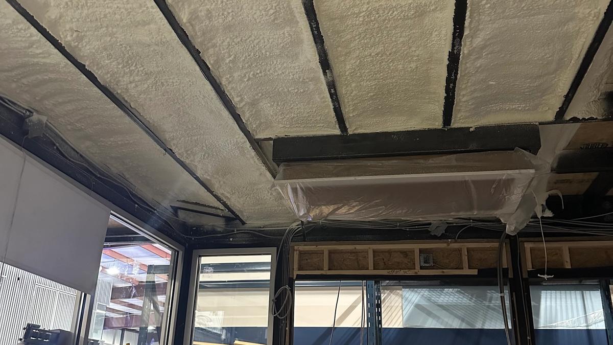 Open cell spray foam insulation in a commercial interior during build-out