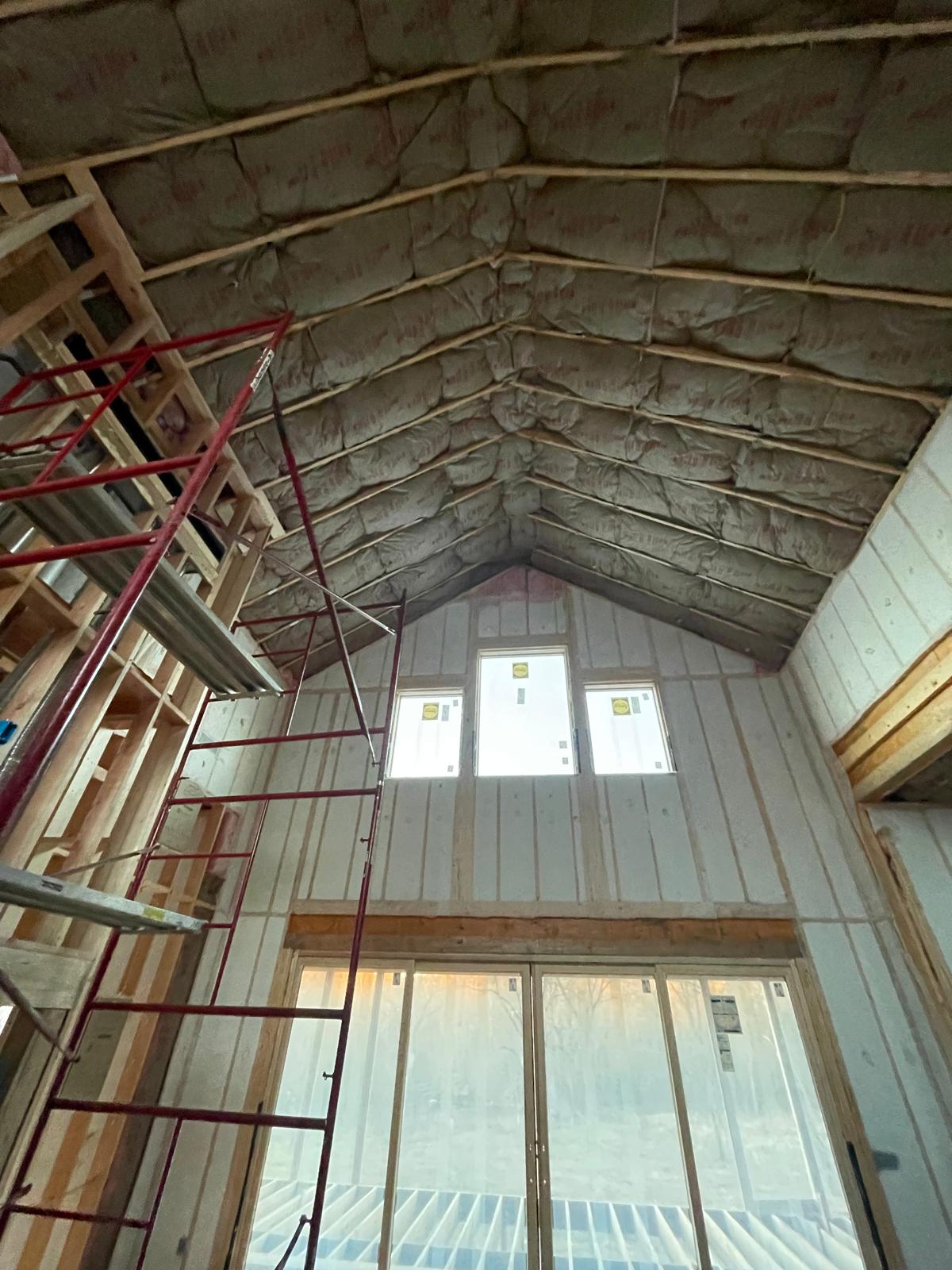 Two-story Bella Vista living room with insulated walls and vaulted ceiling batts