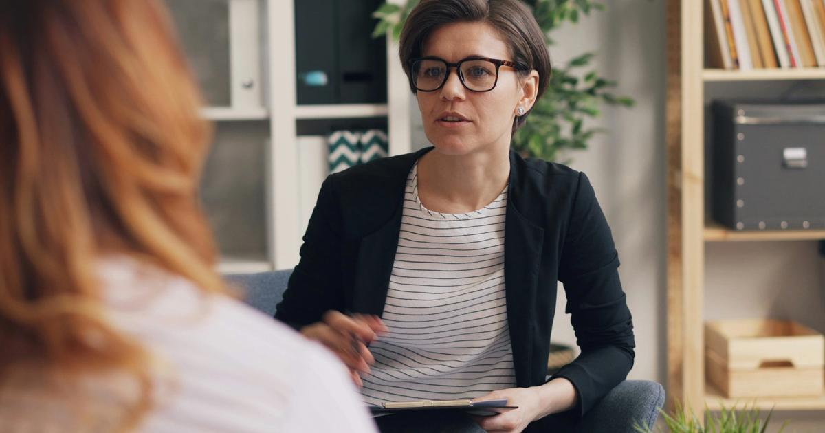 A therapist talking to a client. Find a therapist on Purple Lotus.