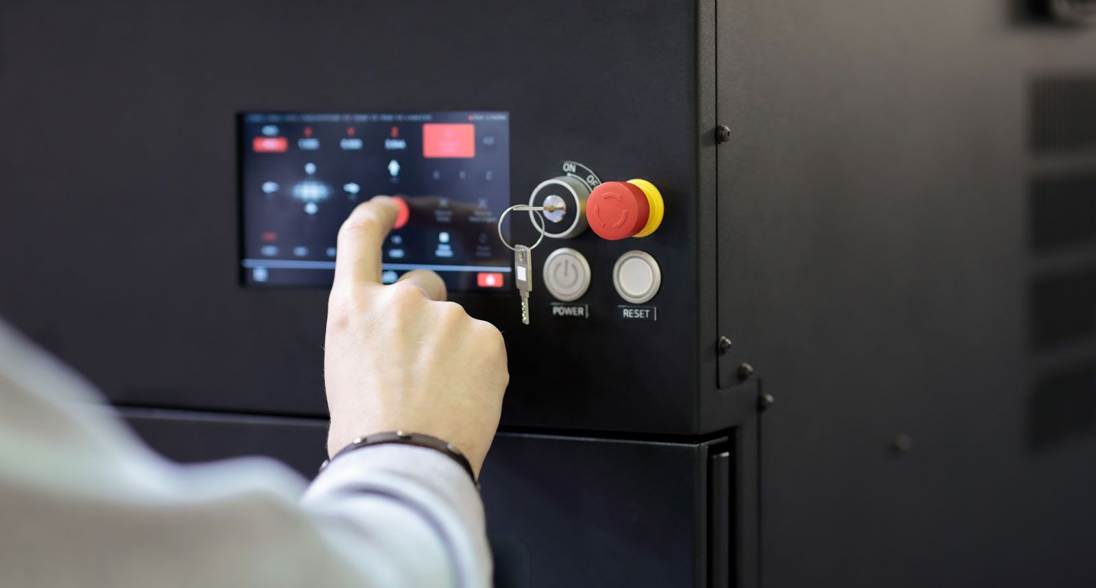 Operator interacting with an industrial touchscreen HMI panel, illustrating how professional interfaces evolve and drift out of sync with real user workflows.