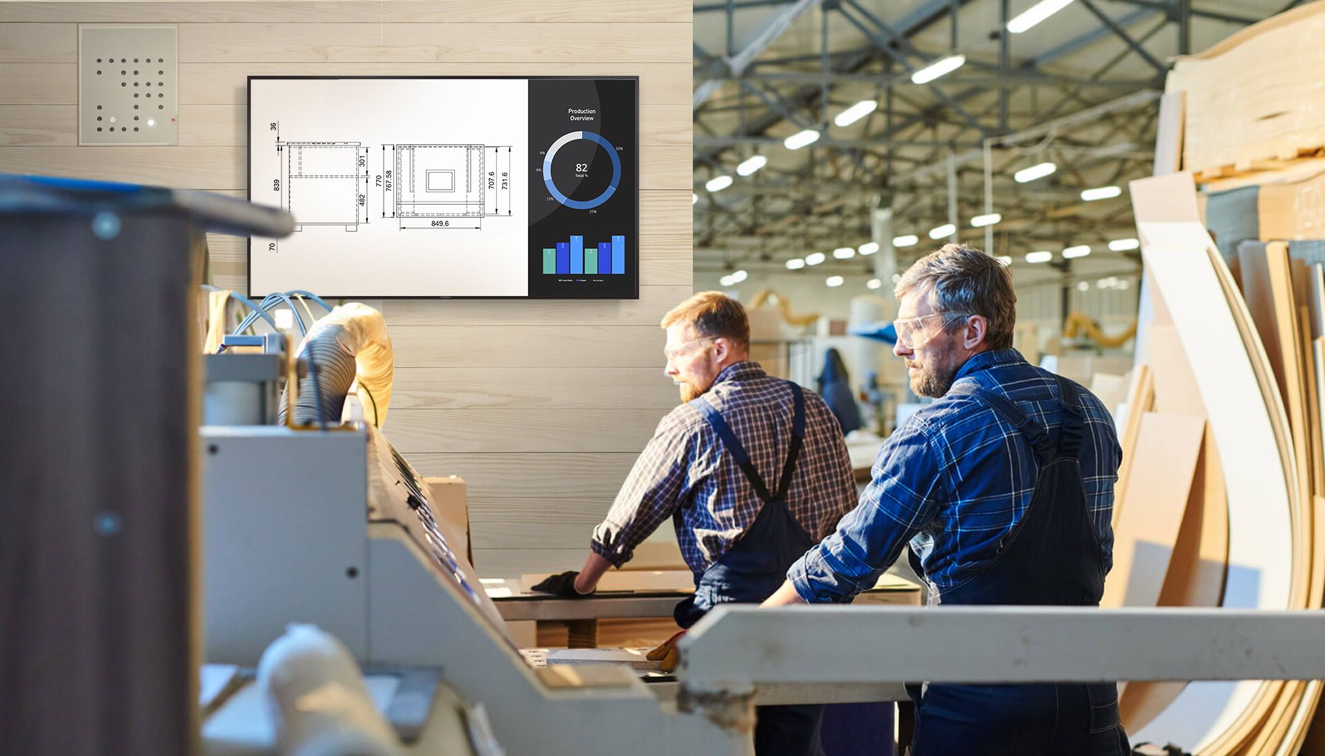 Industrial woodworking operators using CNC machine with GUI display showing production overview, illustrating how structured HMI design supports lifecycle efficiency and ROI in manufacturing.