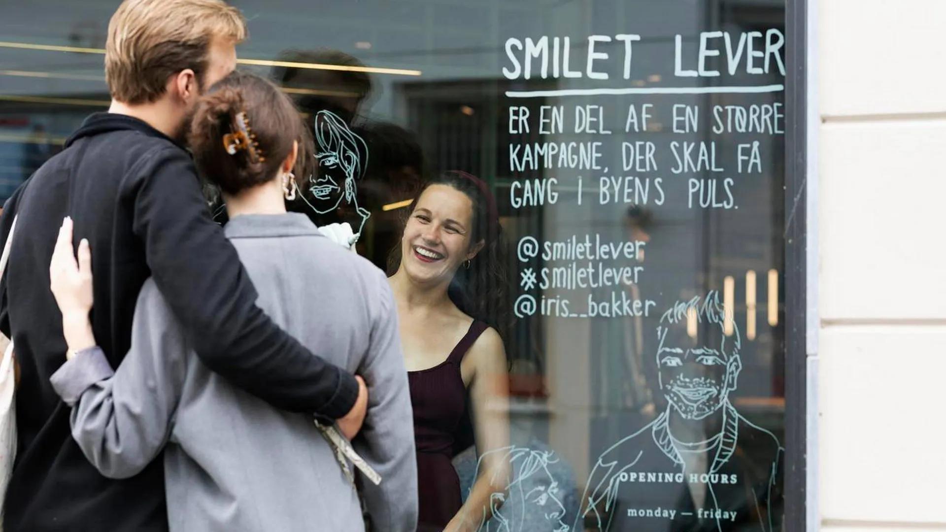 Iris draws portraits on window